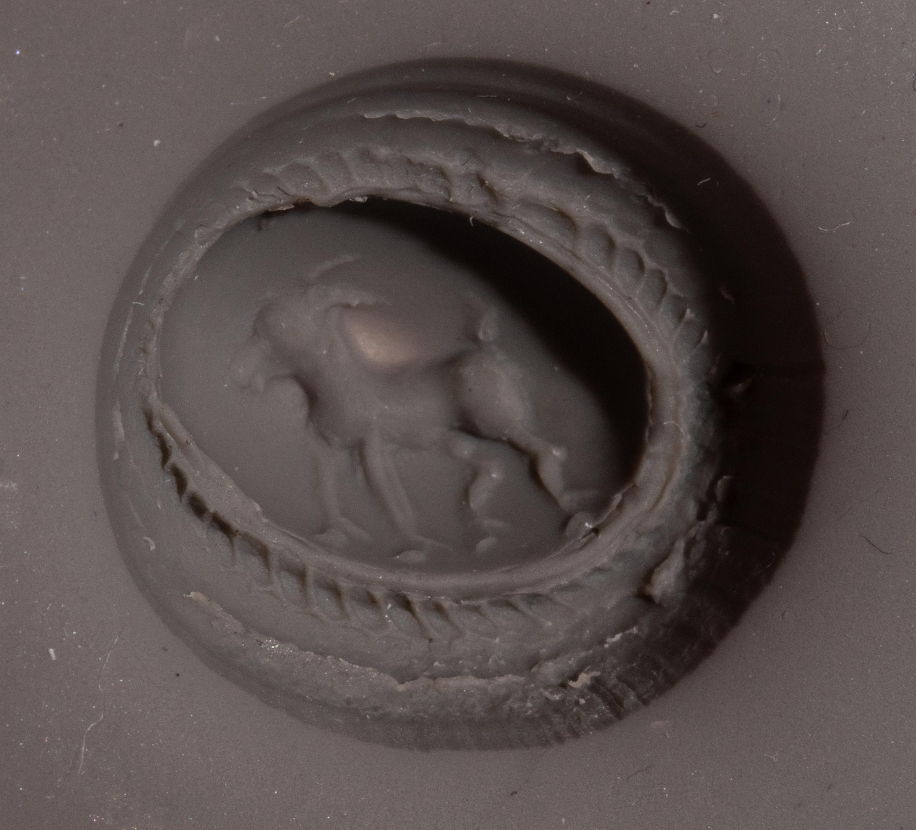 A Roman Gilt-Silver and Garnet Finger Ring with a Ram