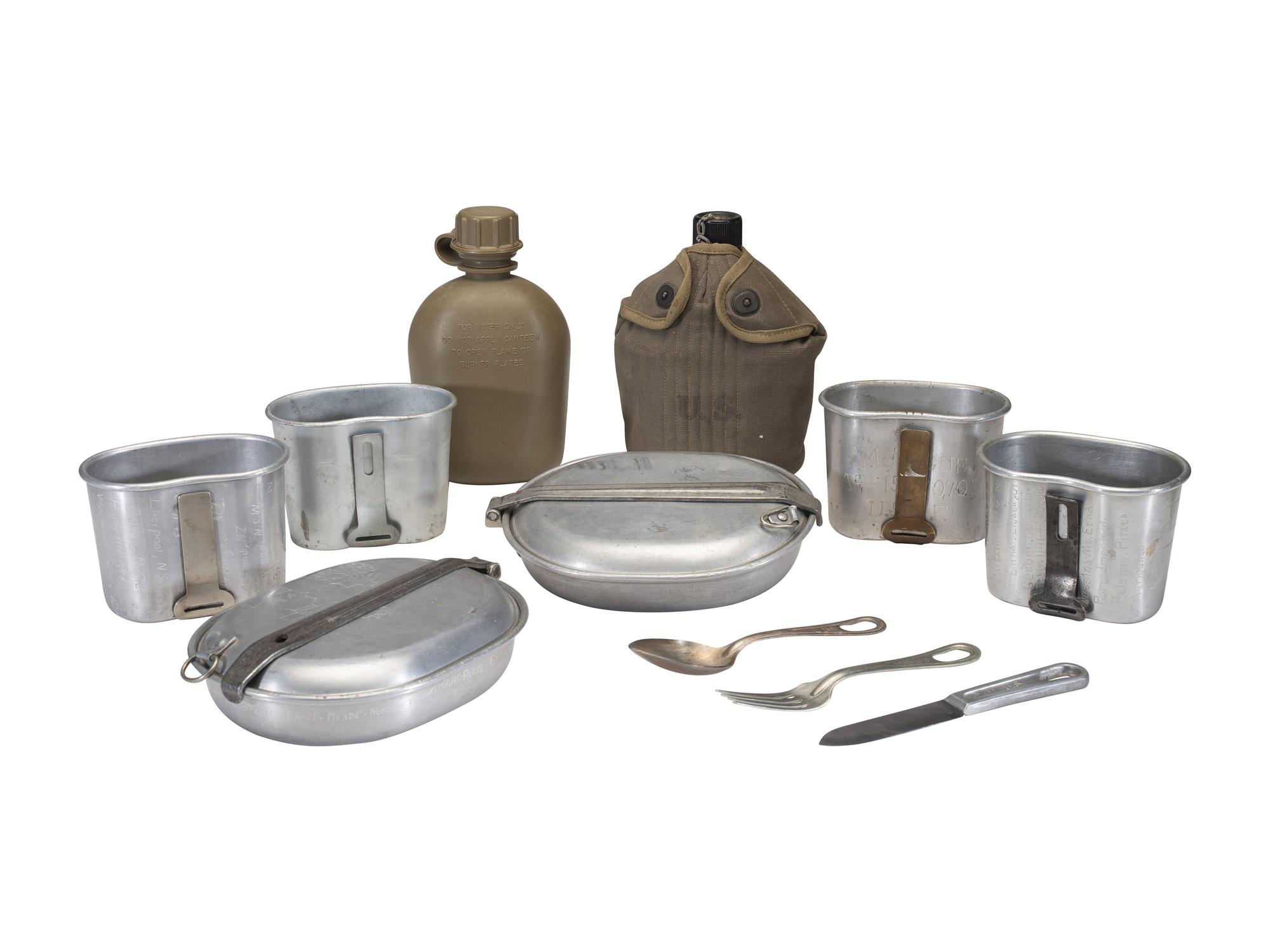 [MILITARIA]. World War II and Korean War-era canteens, canteen covers, and mess kits.