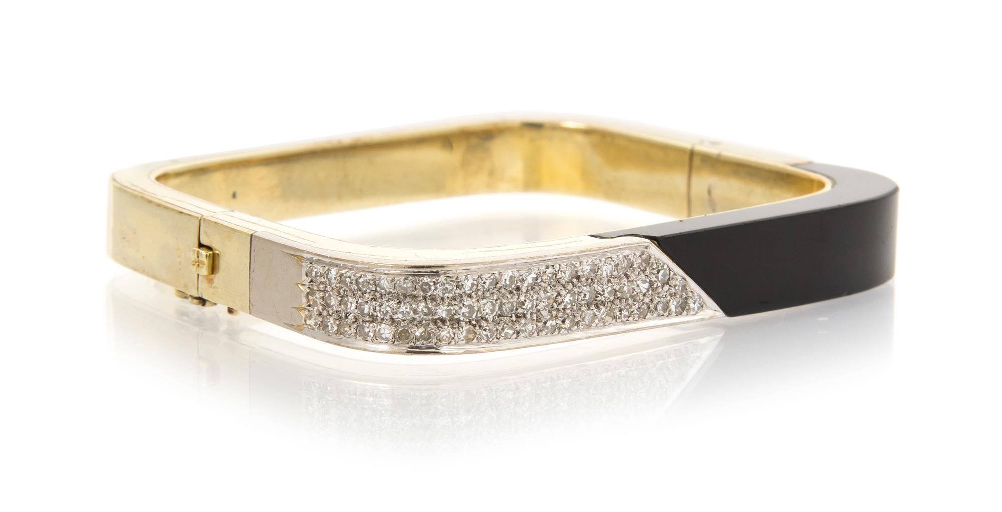 A 14 Karat Yellow Gold, Onyx and Diamond Bangle Bracelet, 29.50 dwts.