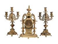 A Continental Gilt Bronze Three-Piece Clock Garniture