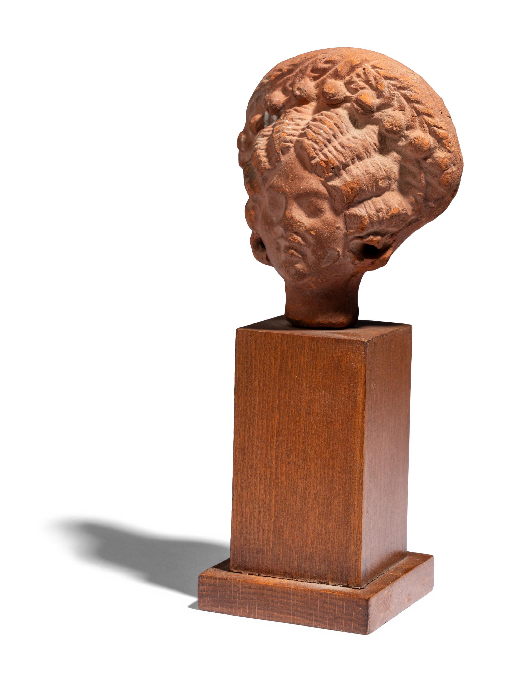 An Egyptian Terracotta Head of a Woman