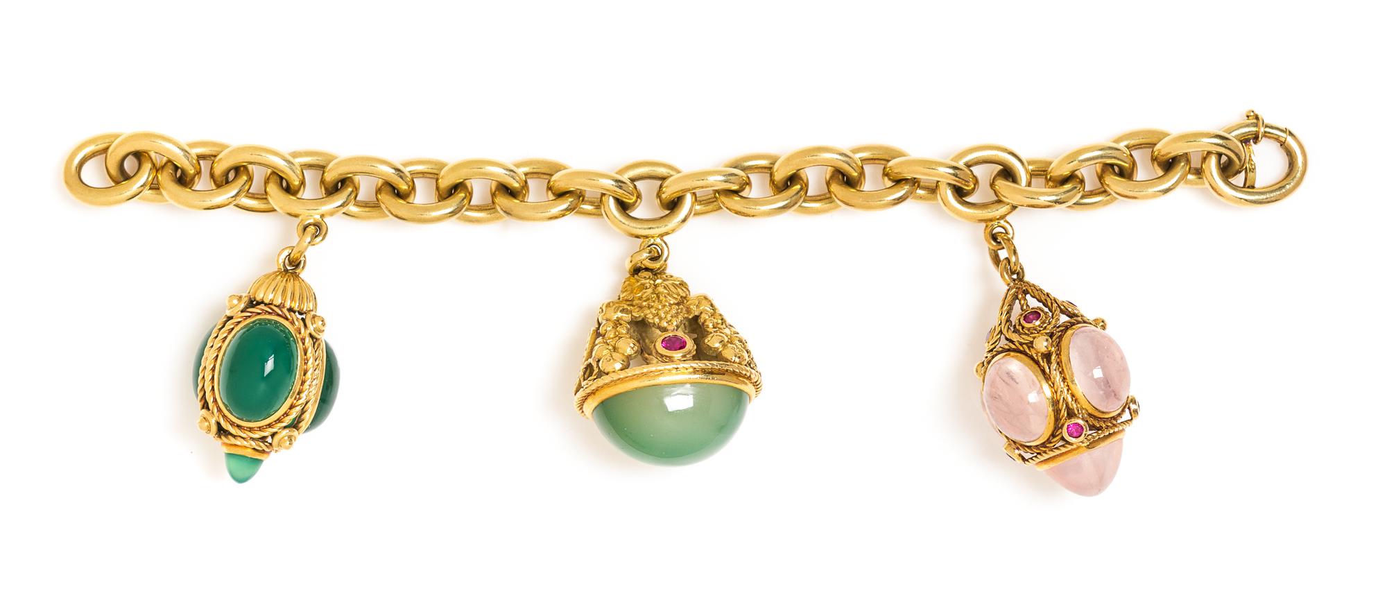 An 18 Karat Yellow Gold Charm Bracelet with Three Gold and Gem Pendant Charms, 74.30 dwts.
