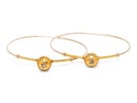 A Pair of Yellow Gold and Diamond Bangle Bracelets,