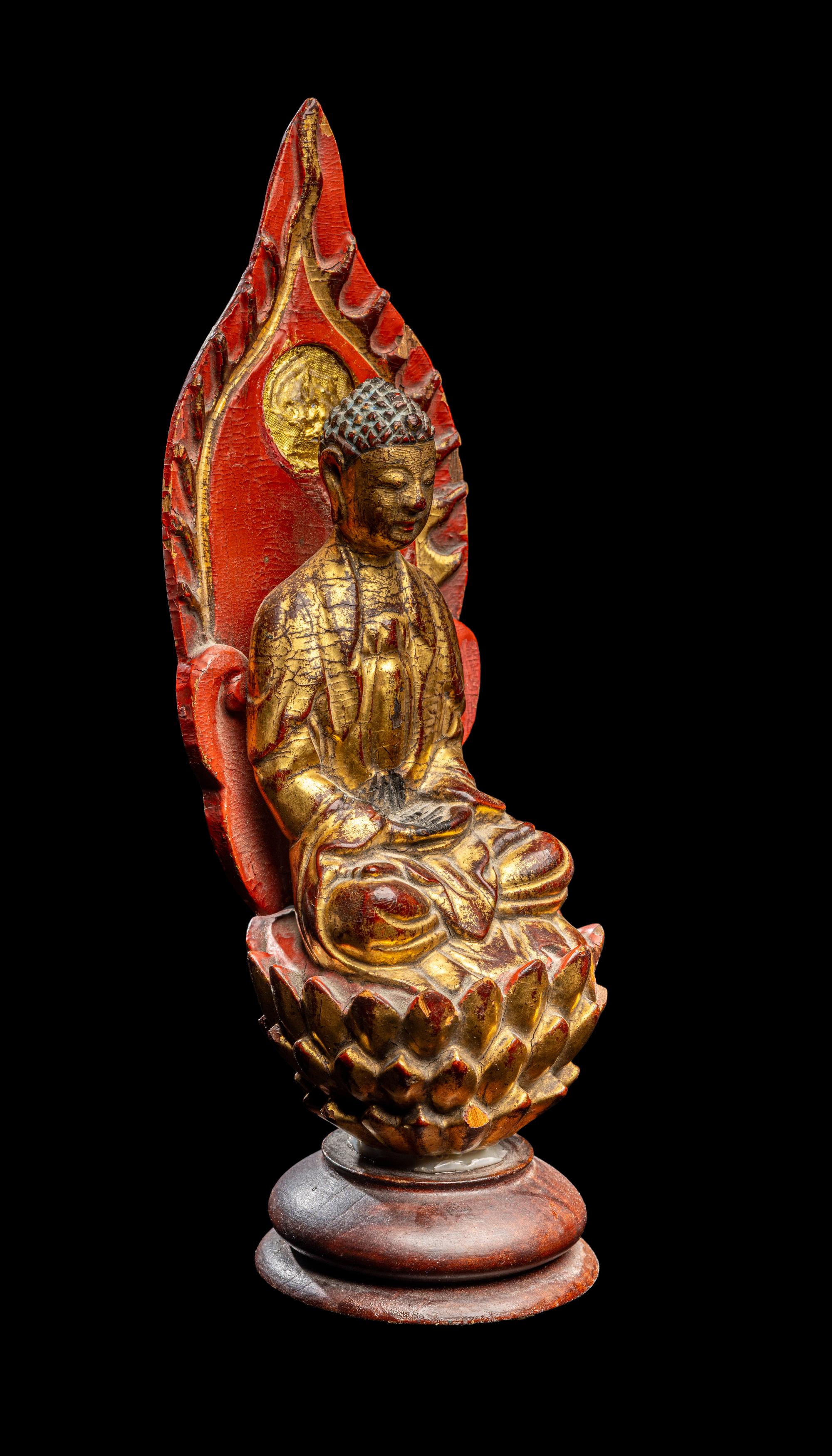 A Gilt and Red Lacquered Wood Figure of Buddha