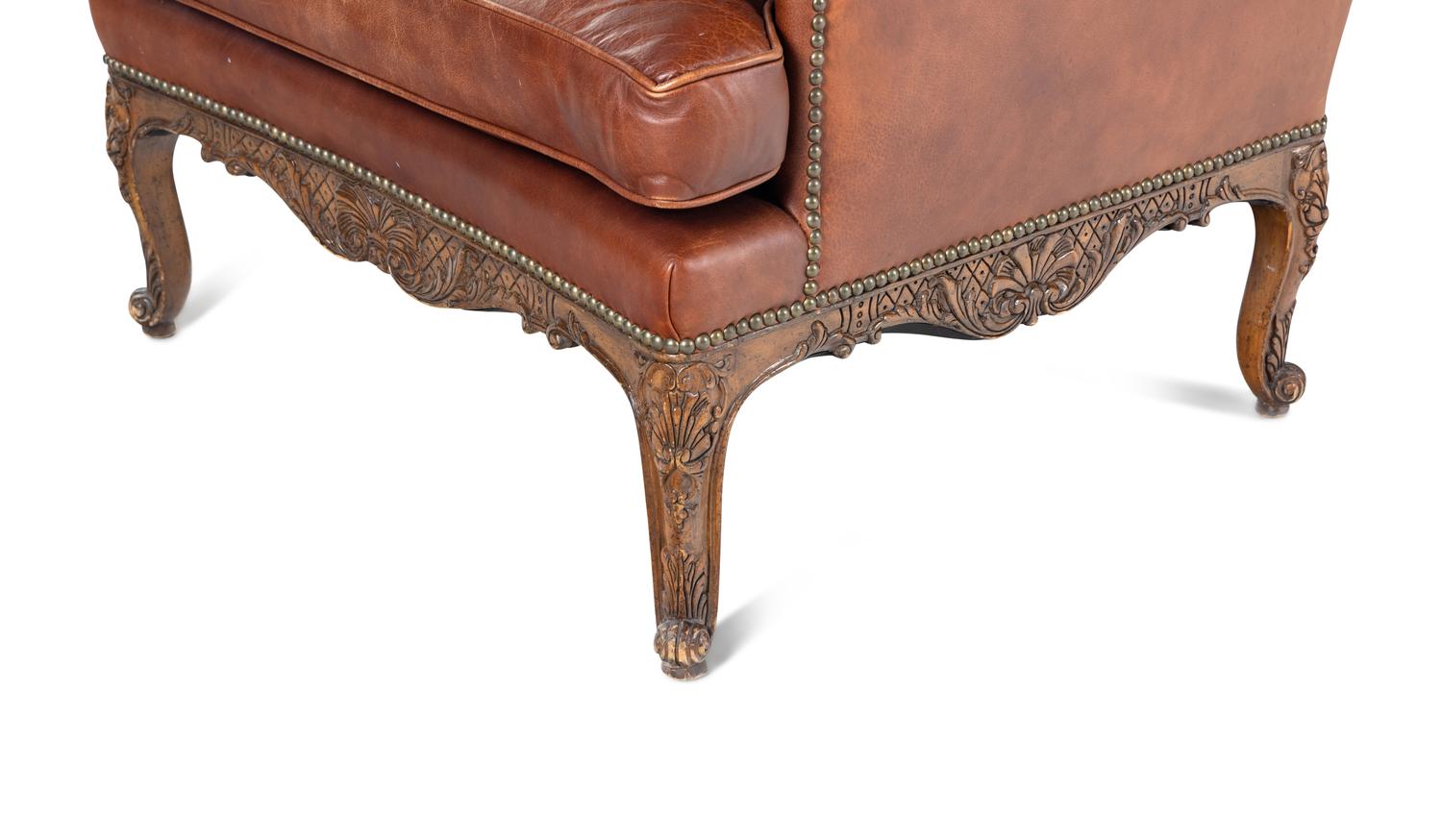 A Pair of Régence Style Leather-Upholstered Wingback Armchairs
