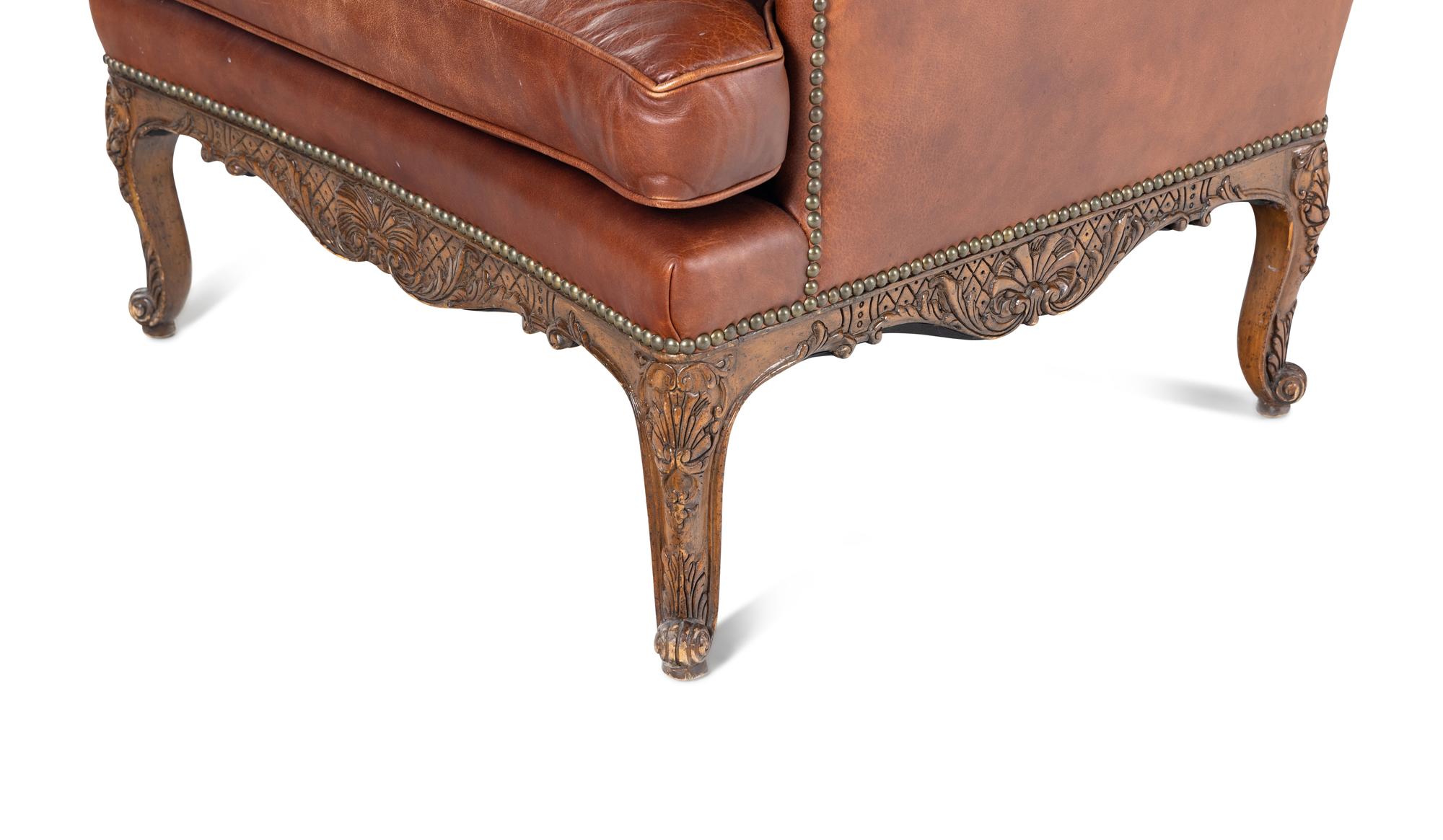 A Pair of Régence Style Leather-Upholstered Wingback Armchairs