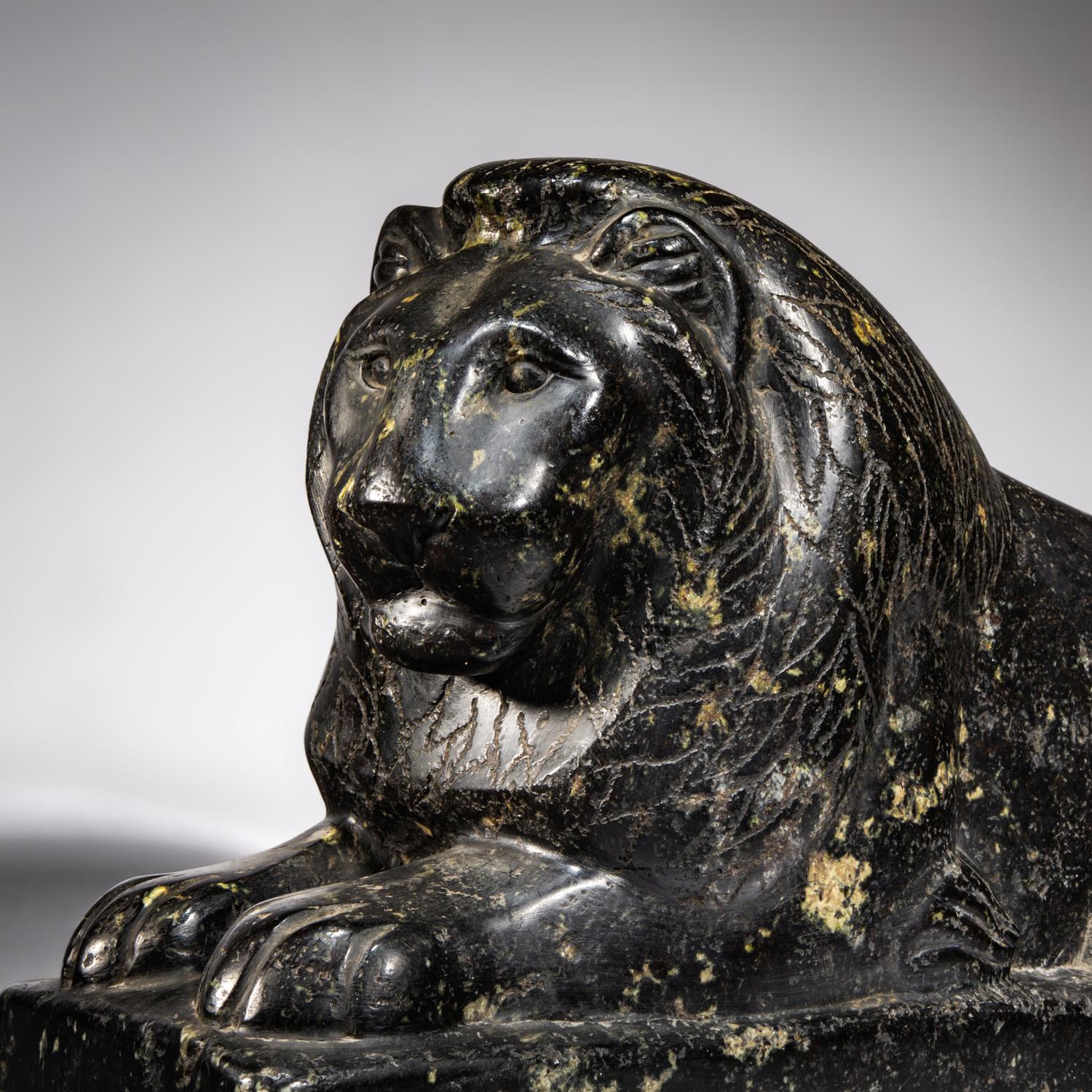 An Egyptian Black Marble Recumbent Lion
