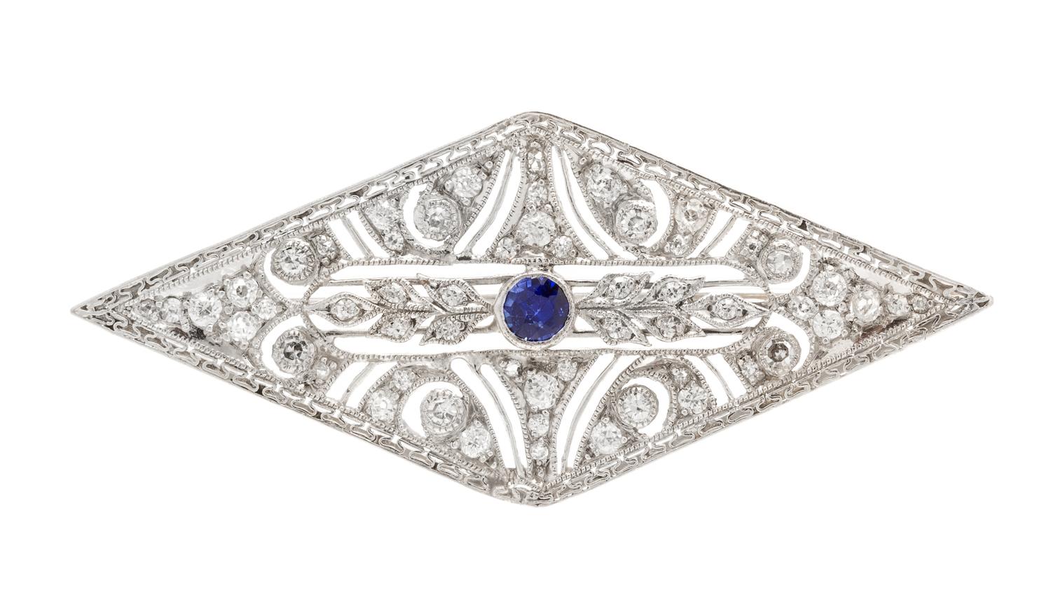An Art Deco, Platinum, Diamond and Synthetic Sapphire Brooch, 4.80 dwts.