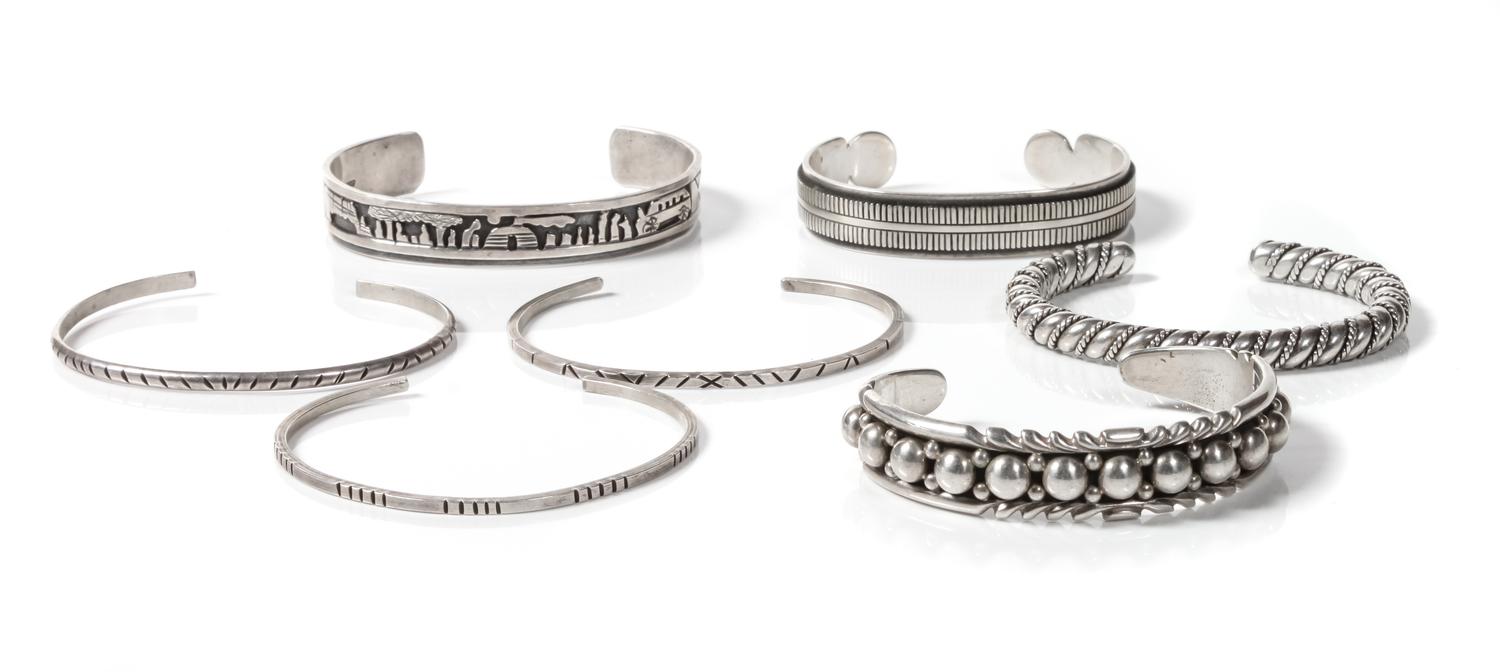 Seven Navajo Silver Bracelets Length of one 5 3/4 x opening 1 3/8 x width 1/4 inches