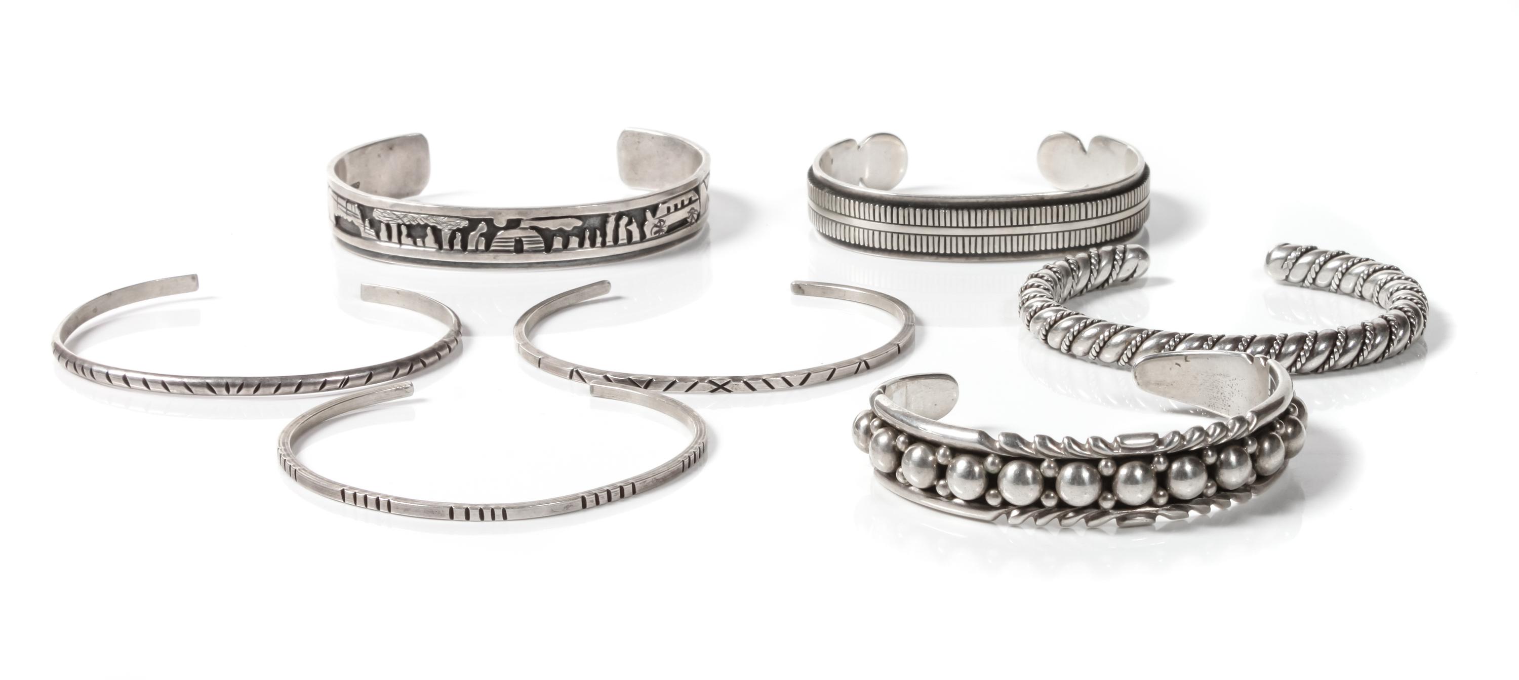 Seven Navajo Silver Bracelets Length of one 5 3/4 x opening 1 3/8 x width 1/4 inches