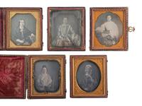 [EARLY PHOTOGRAPHY]. A group of 13 daguerreotype portraits of women holding fans and parasols, highlighted by two half plate examples, including: