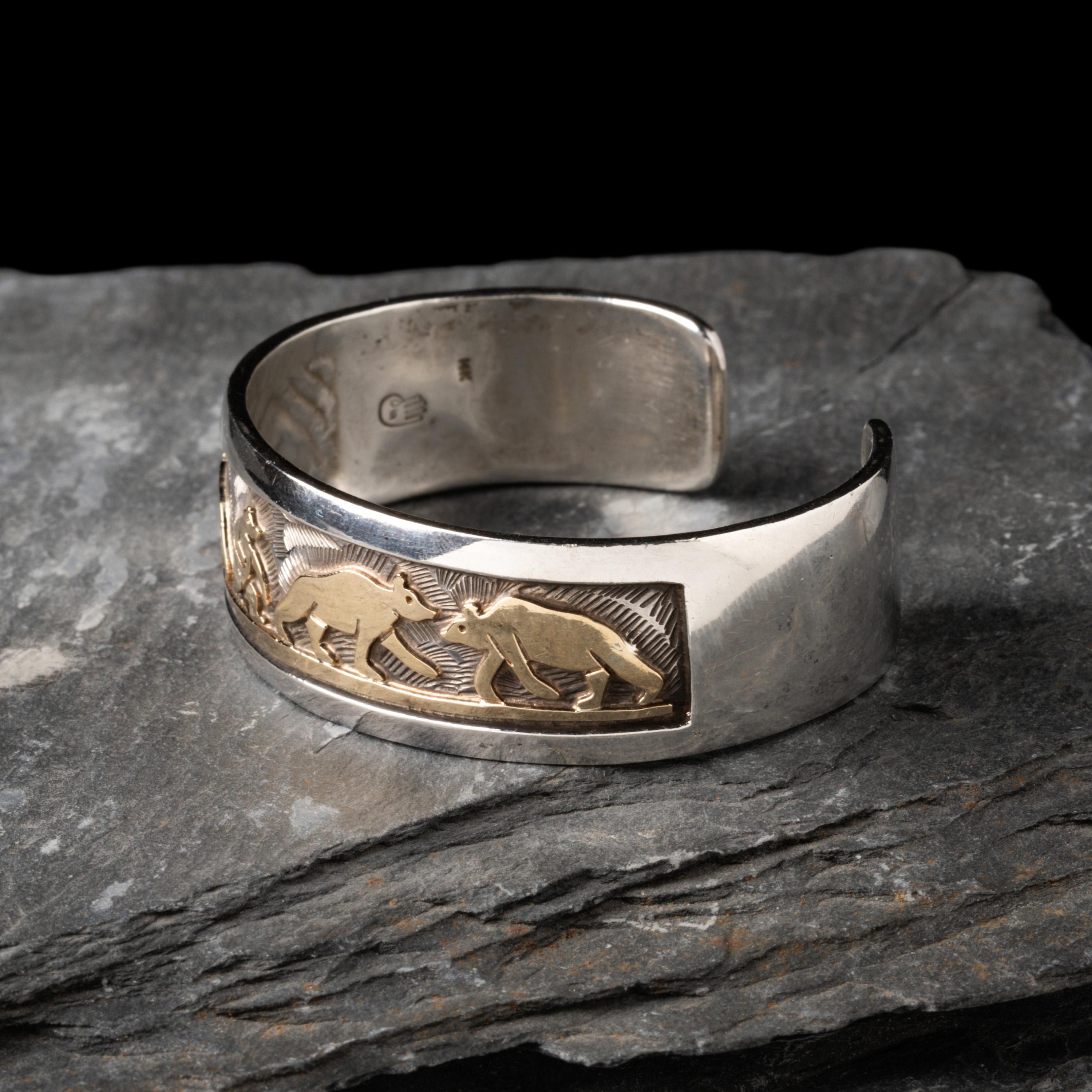 Watson Honanie (Hopi, 1953-2023) — Sterling Silver with 14K Gold Overlay Cuff Bracelet, with Bear Scene