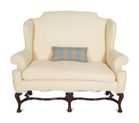 A William & Mary Style Carved Oak Upholstered Wing Back Settee