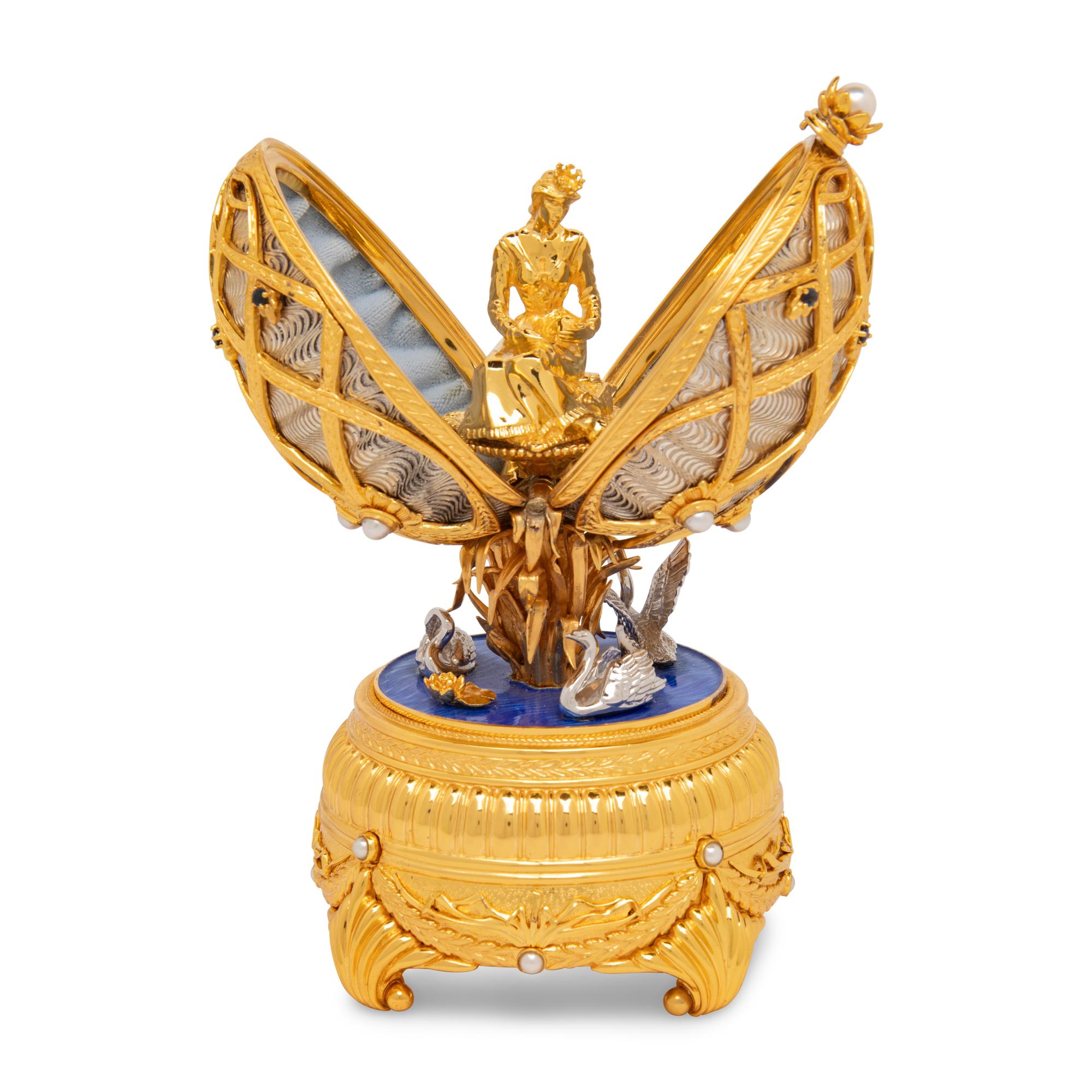 A Silver, Gilt and Enamel Decorated Swan Lake Egg-Form Music Box