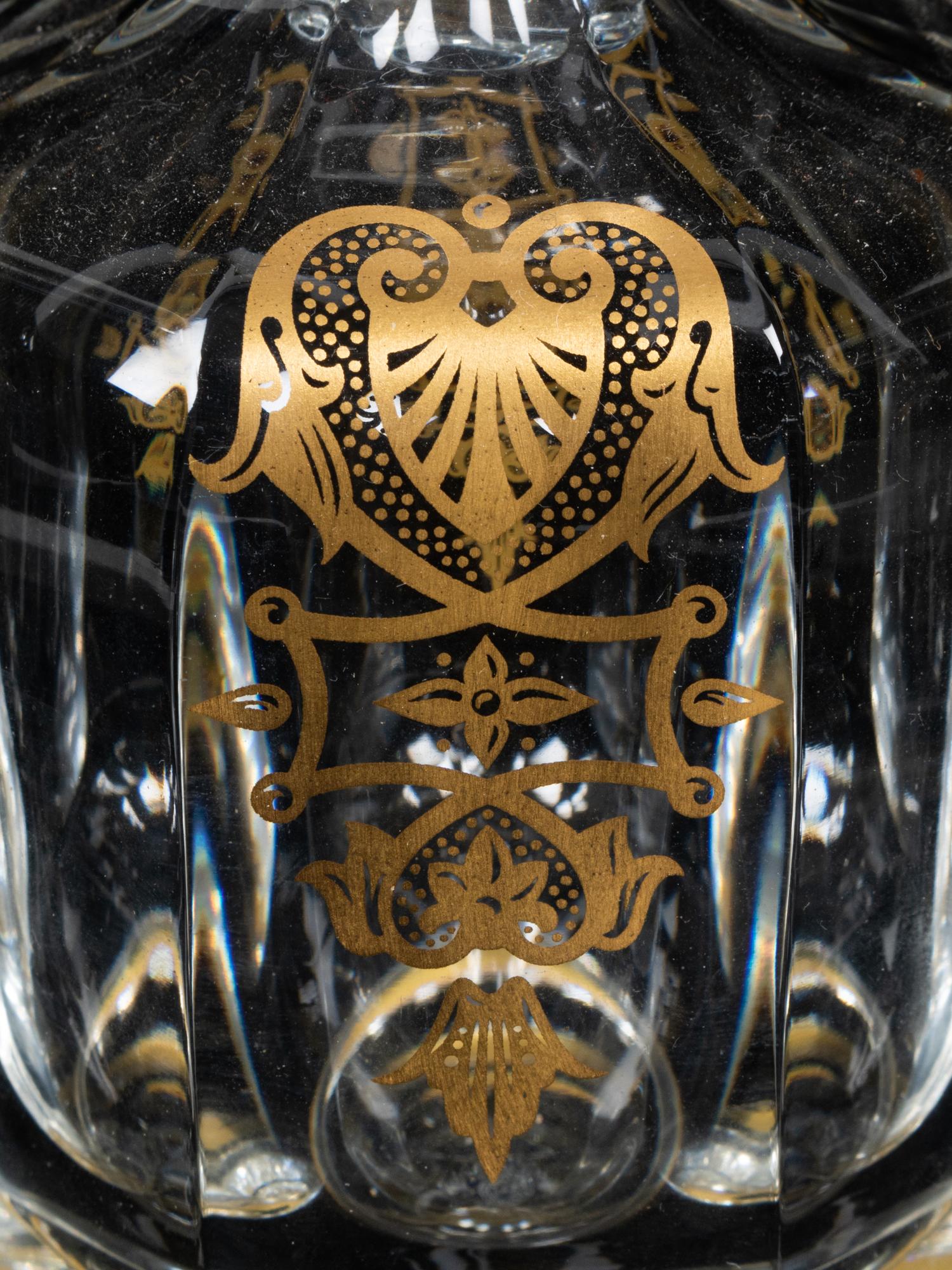 A Set of Three Baccarat Glass Decanters with Gilt Decoration