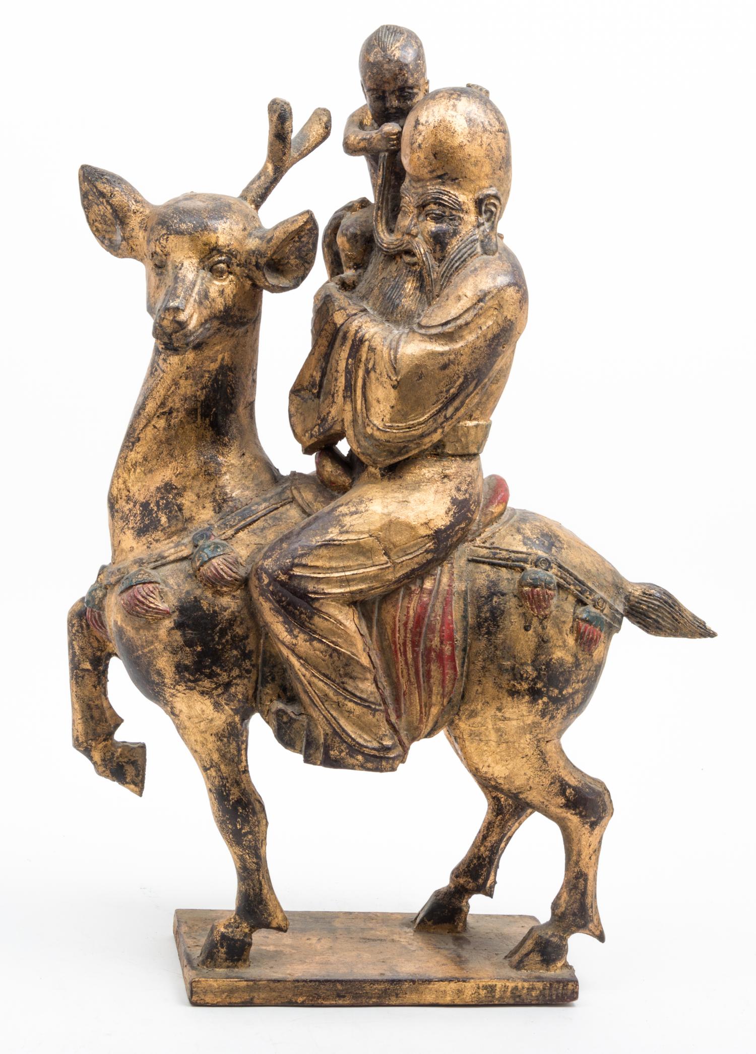A Gilt and Red Lacquered Wood Figural Group Height 27 inches.