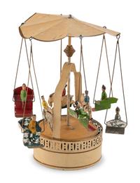 A German Painted Tin Swing Carousel Toy