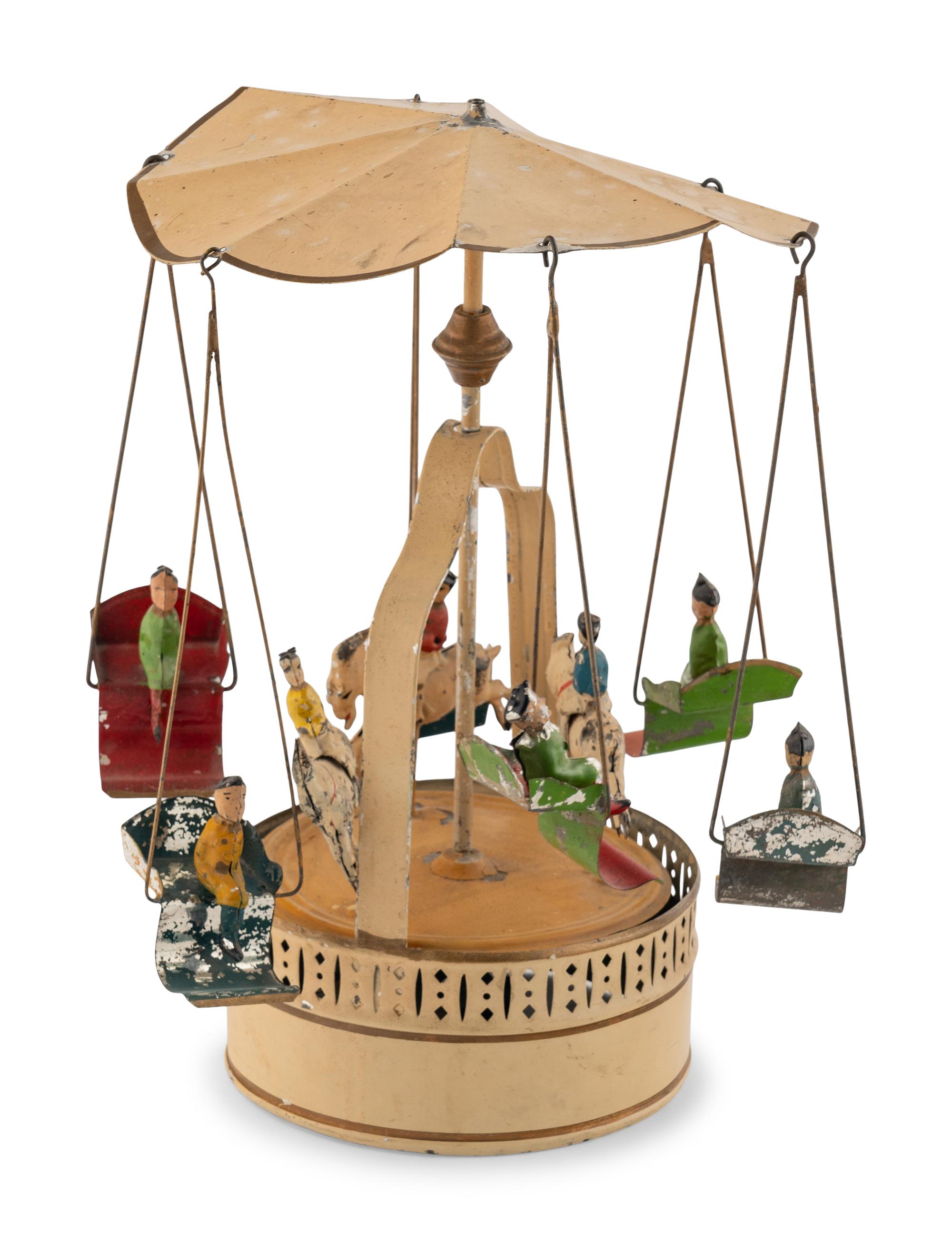 A German Painted Tin Swing Carousel Toy