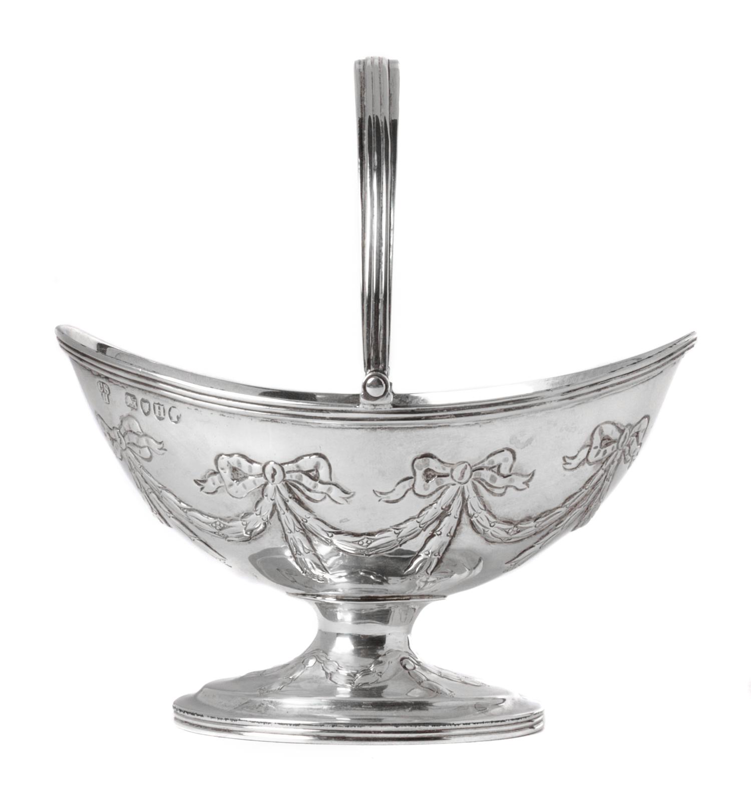An English Silver Handled Basket, Charles Stuart Harris, London, 1883-84, with a swing handle and engraved swag decoration.