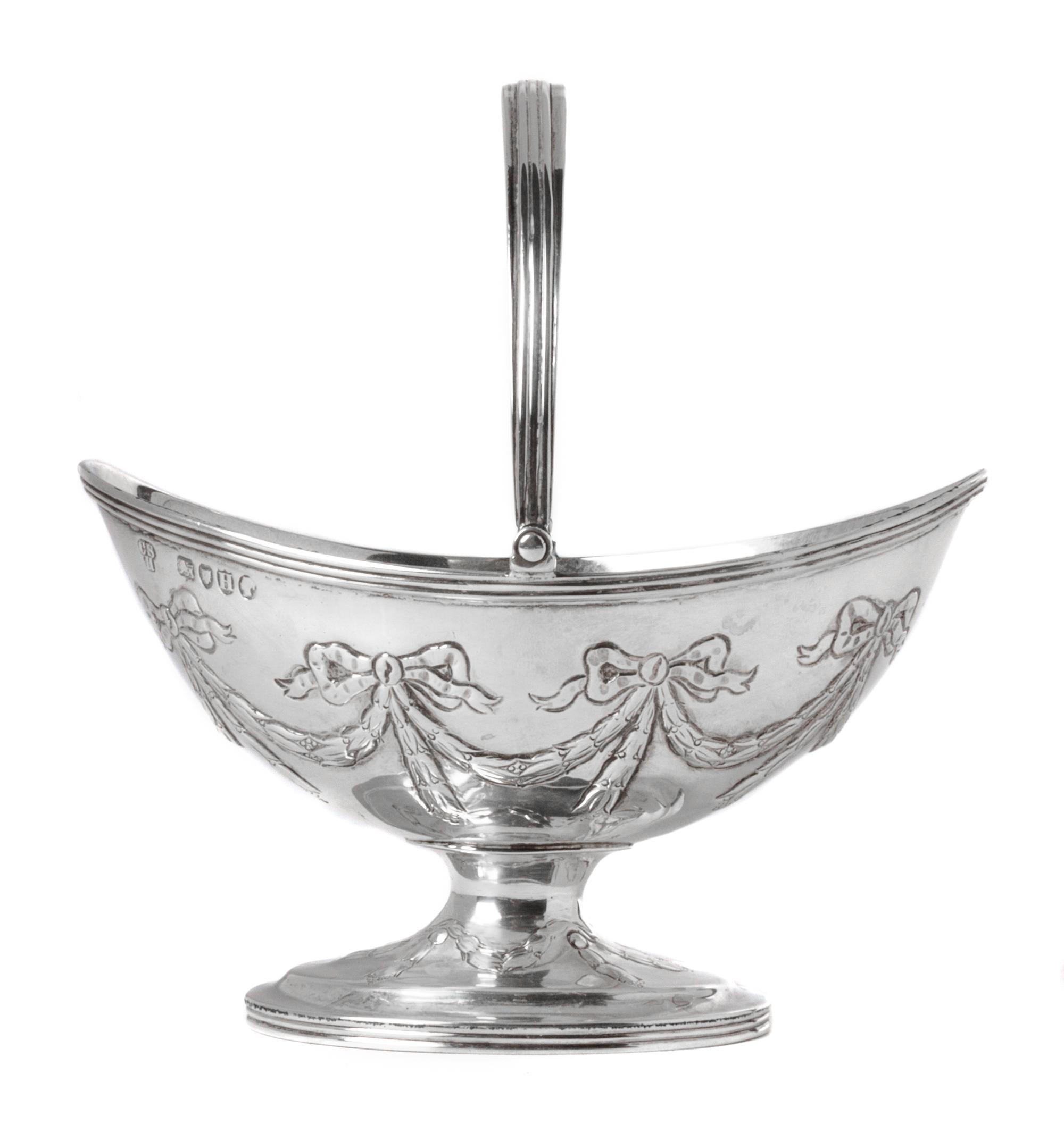An English Silver Handled Basket, Charles Stuart Harris, London, 1883-84, with a swing handle and engraved swag decoration.