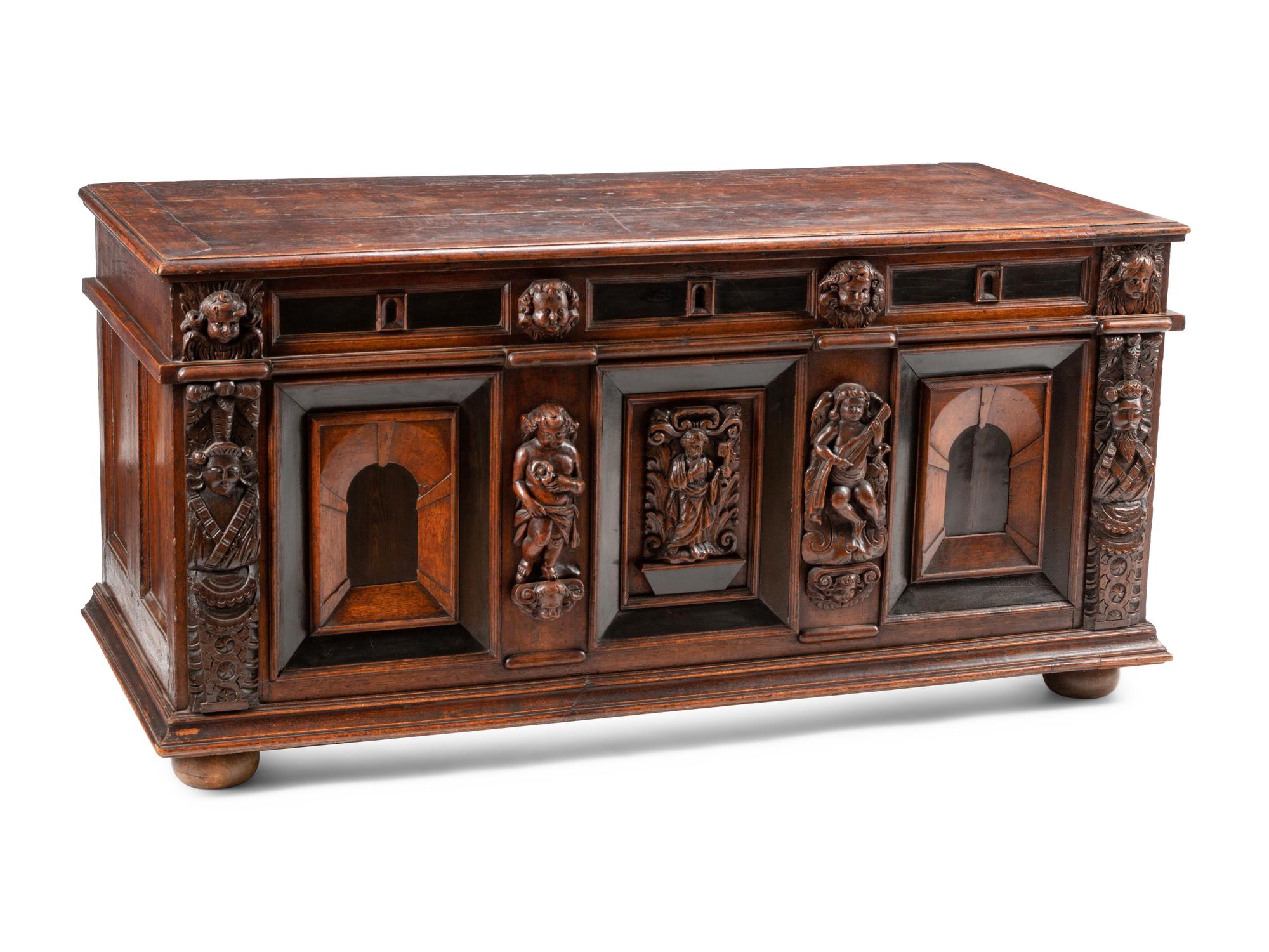An Italian Carved Oak and Walnut Cassone