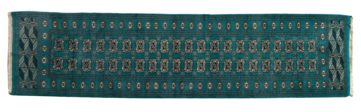A Bokhara Wool Rug, 9 feet 2 inches x 2 feet 6 inches.