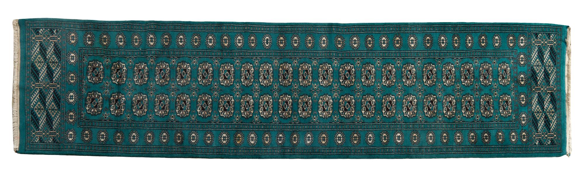 A Bokhara Wool Rug, 9 feet 2 inches x 2 feet 6 inches.