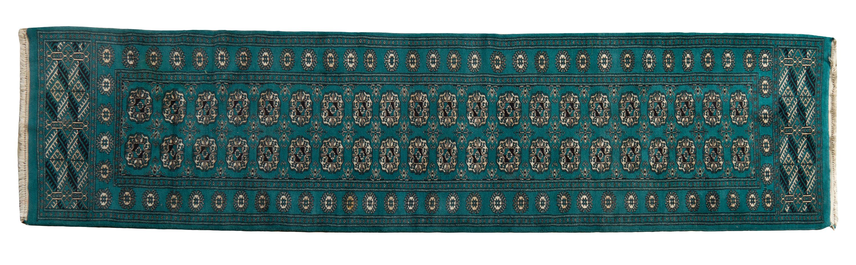 A Bokhara Wool Rug, 9 feet 2 inches x 2 feet 6 inches.