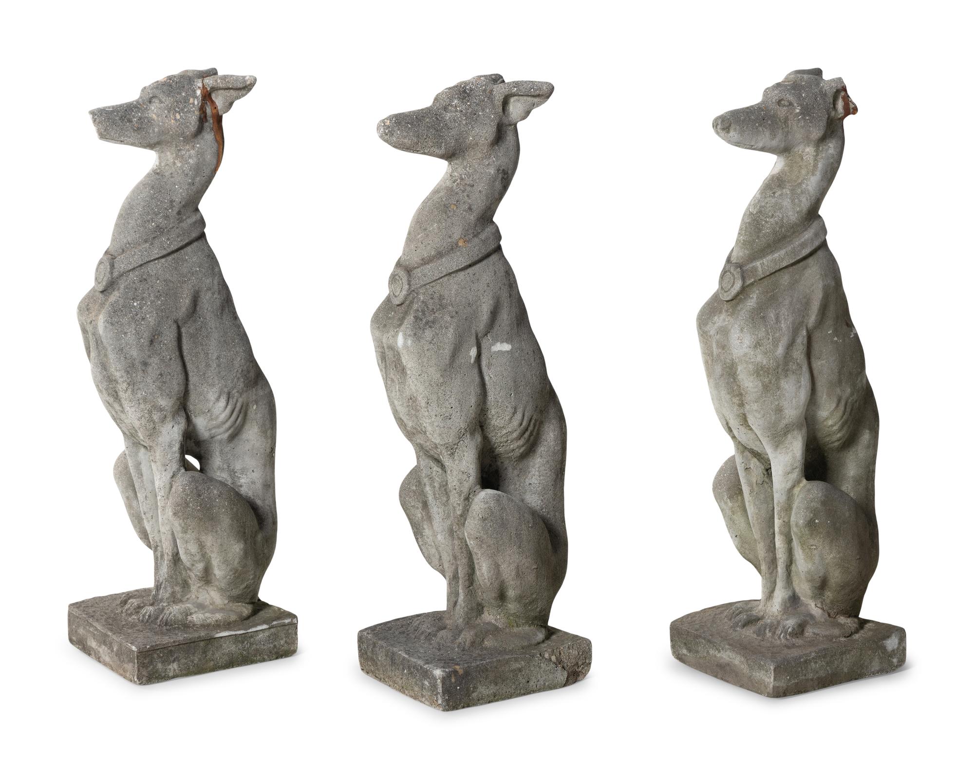 A Group of Cast Stone Hound Form Garden Statues