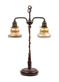 A Tiffany Studios Favrile Glass and Bronze Double Student Lamp Height 25 inches.