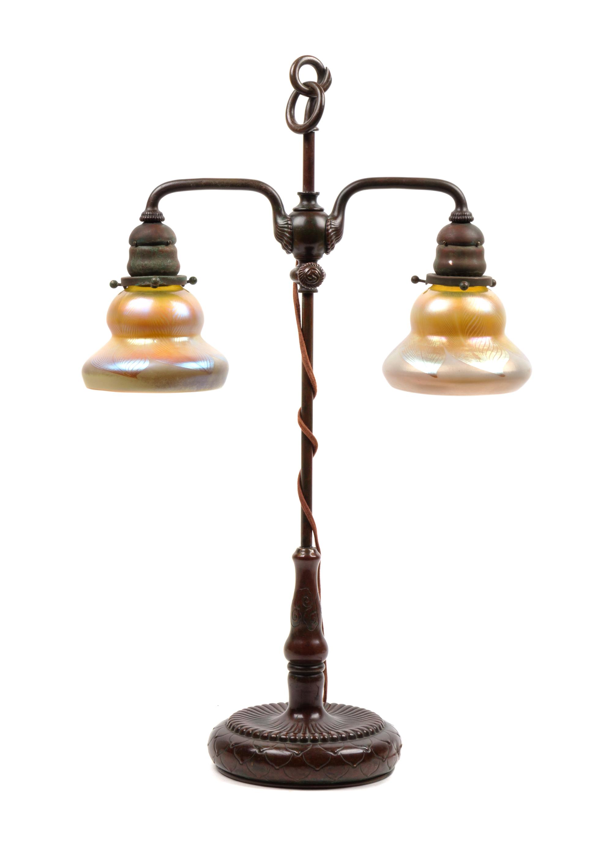 A Tiffany Studios Favrile Glass and Bronze Double Student Lamp Height 25 inches.