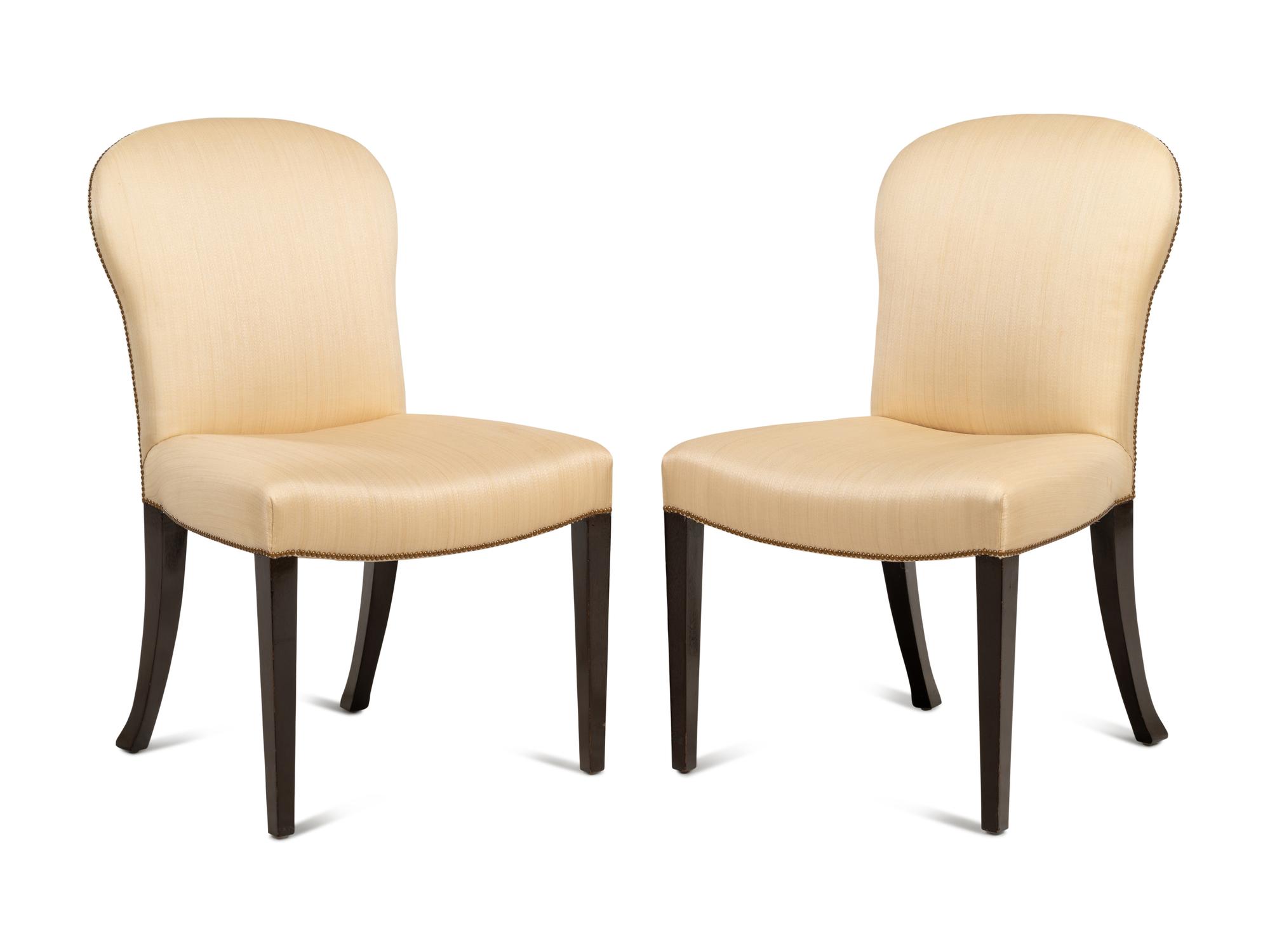 A Set of Eight Saddle Dining Chairs