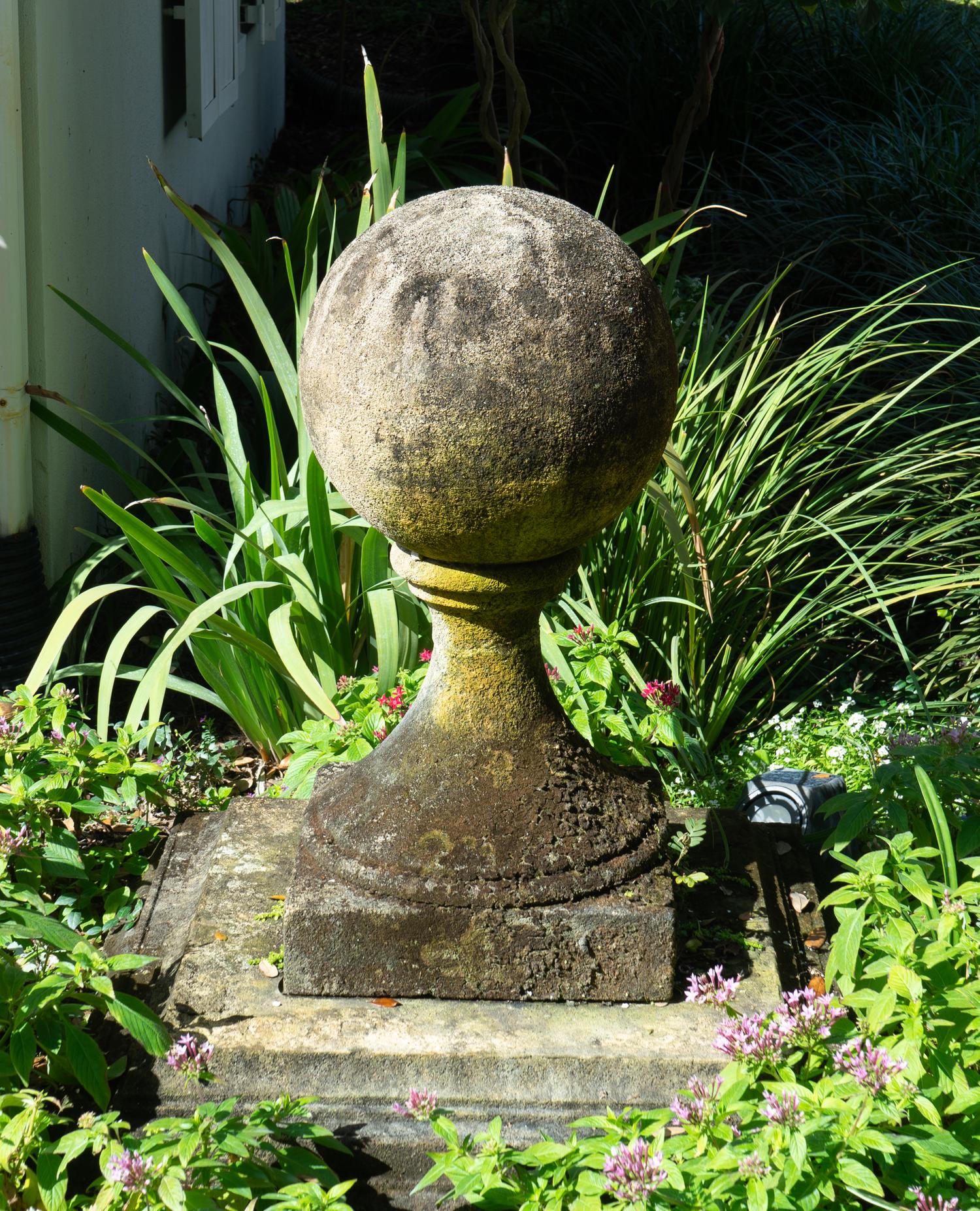 A Pair of Carved Stone Sphere Form Capitals on Pyramid Bases