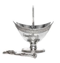A George III Silver Sugar Basket, James Mince, London, 1791, having a swing handle, an engraved foliate band at the upper rim and ermin