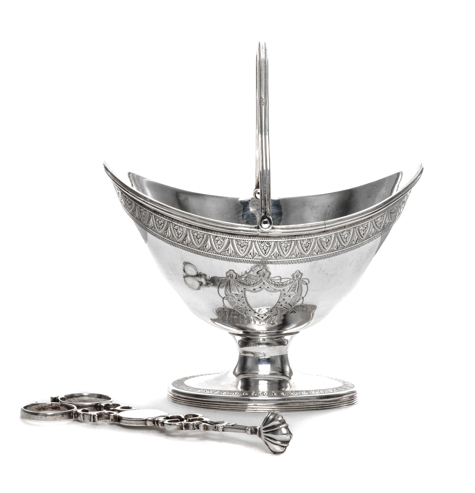 A George III Silver Sugar Basket, James Mince, London, 1791, having a swing handle, an engraved foliate band at the upper rim and ermin