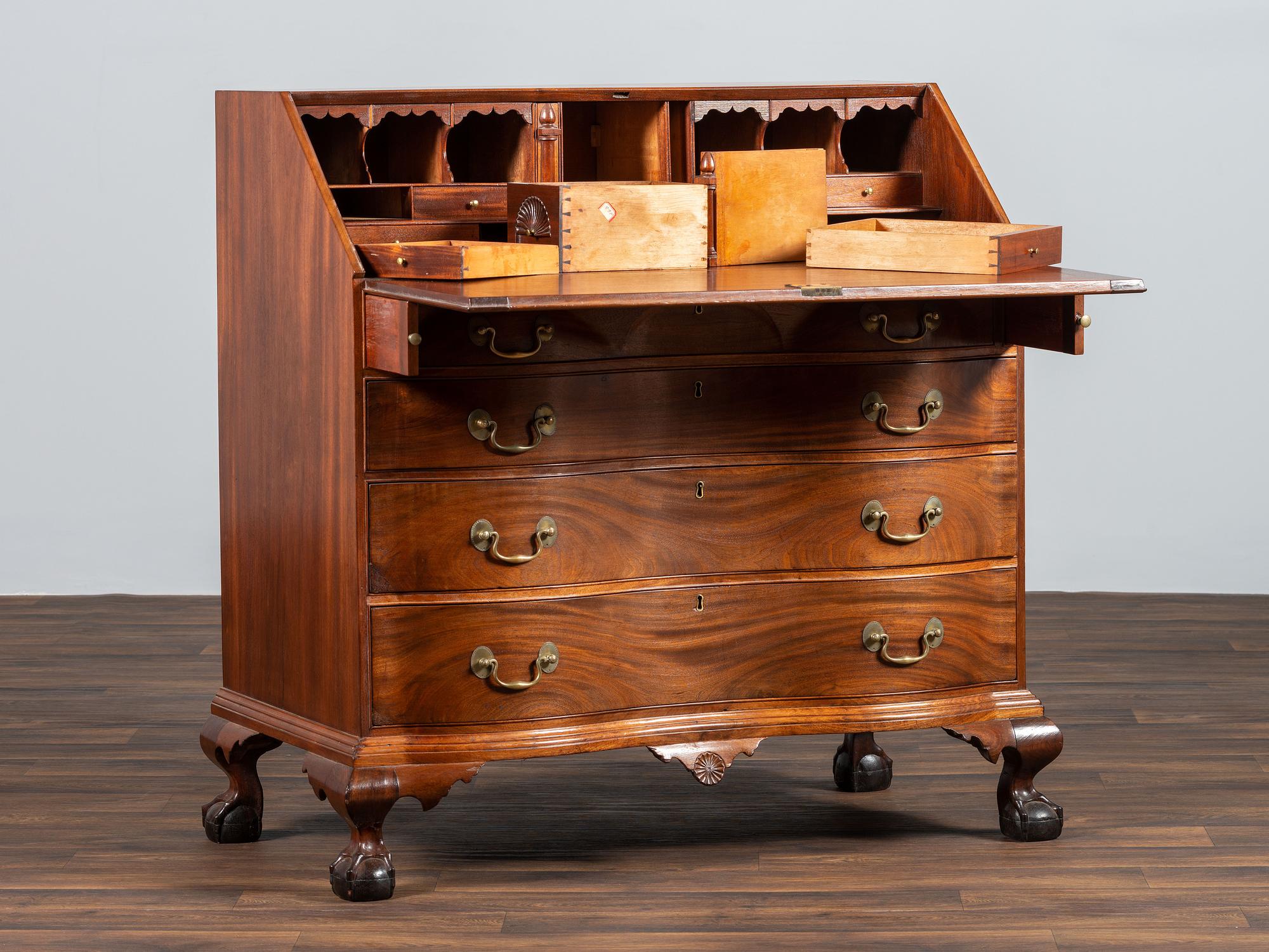 A Chippendale Carved Mahogany Reverse Serpentine Block-Front Desk