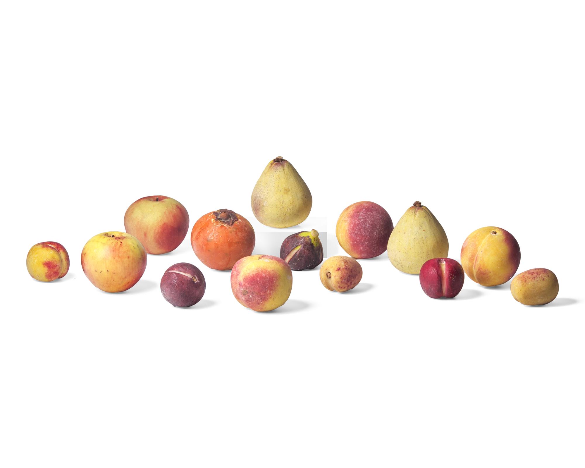 A Collection of Fourteen Carved and Painted Stone fruit