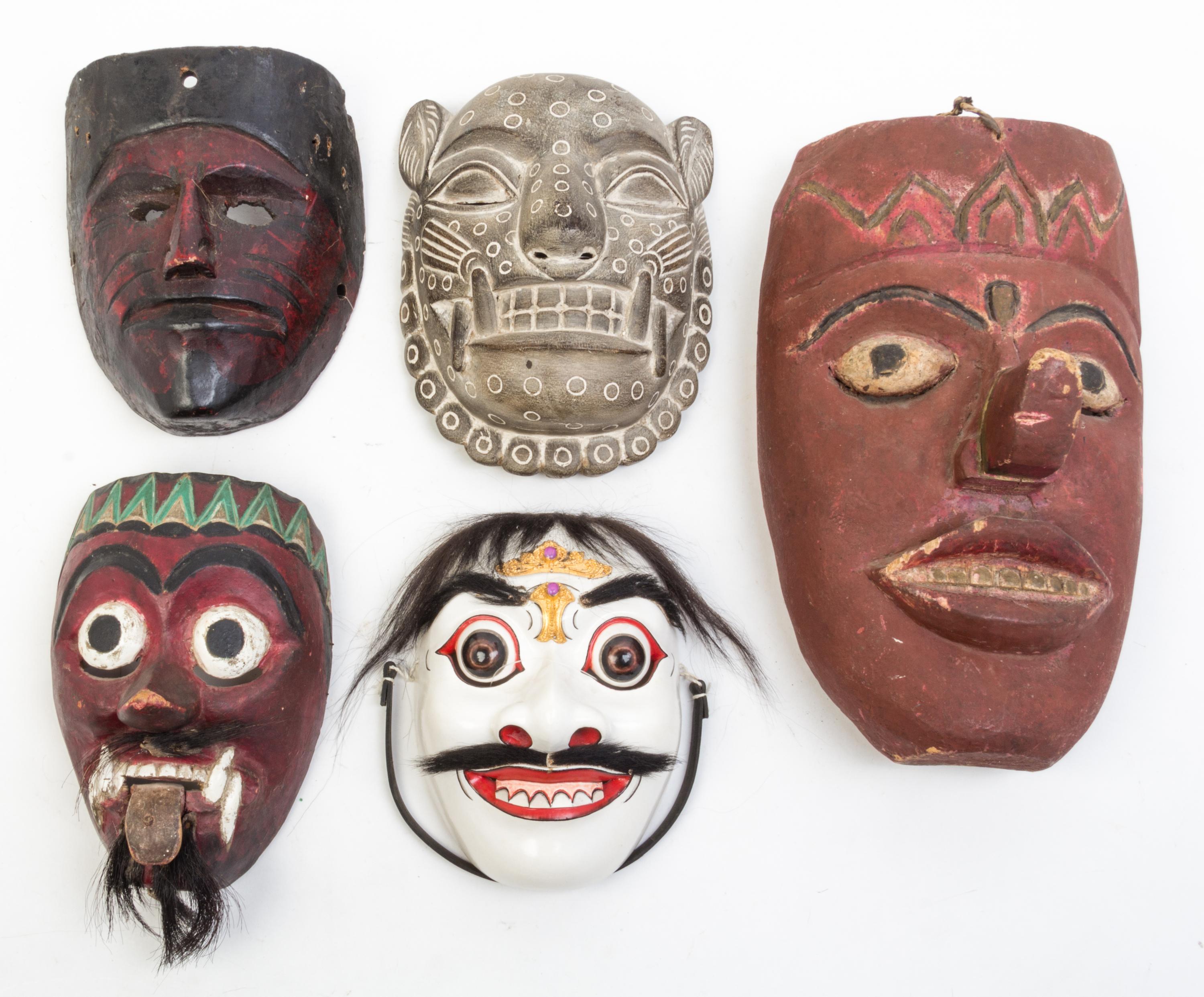 A Collection of Seven Masks Height of largest 17 inches.