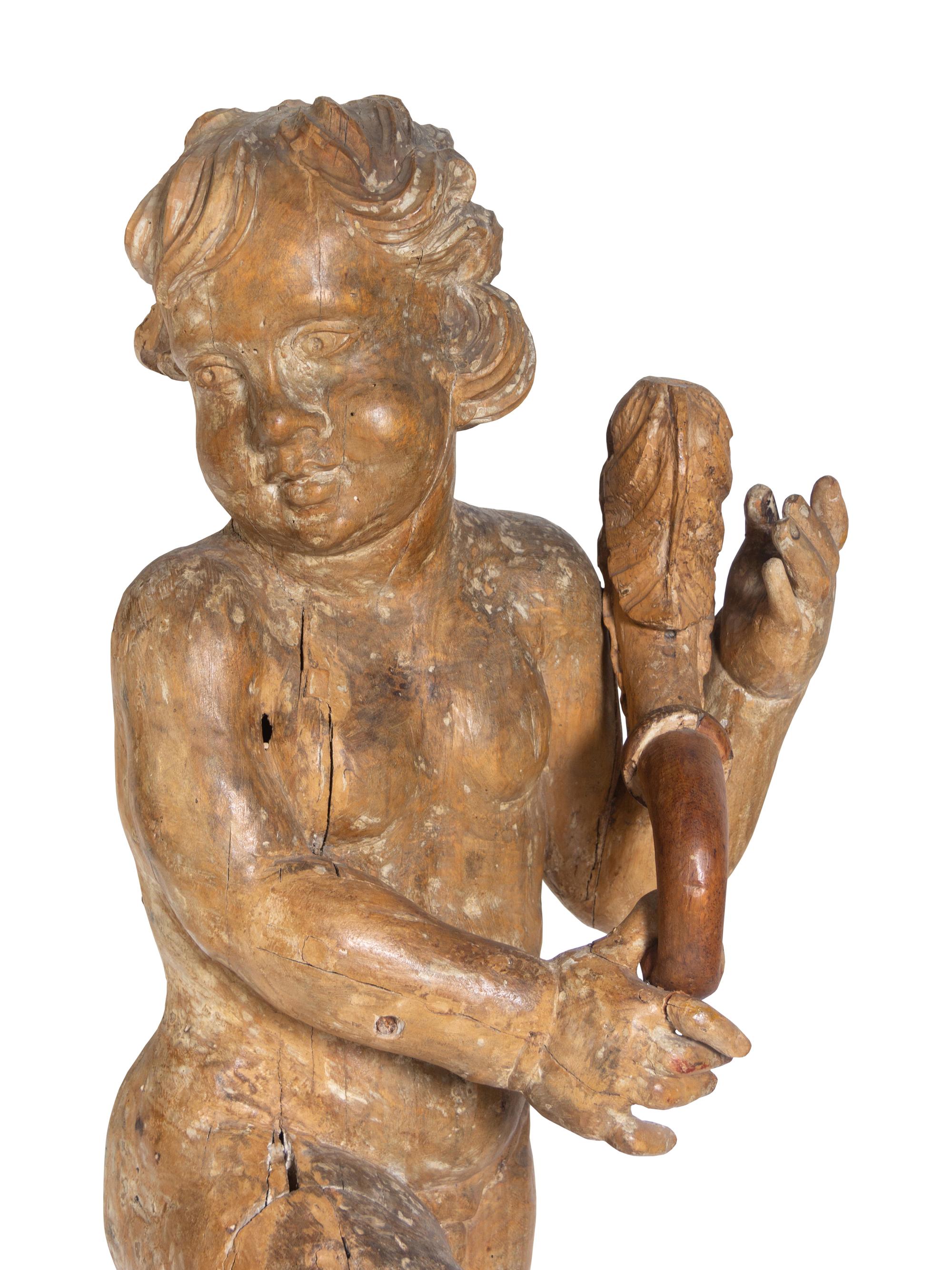 A Pair of Florentine Carved Walnut Figures of Putti on Plinths