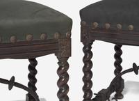 A Pair of Spanish Baroque Style Stained Beechwood and Wrought Iron Stools
