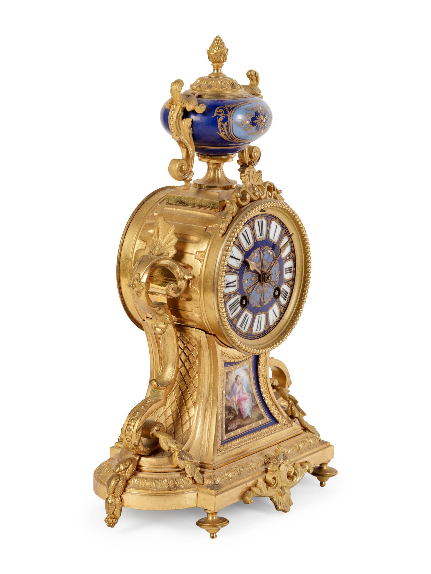 A Louis XVI Style Porcelain Inset Gilt Bronze Mantel Clock
