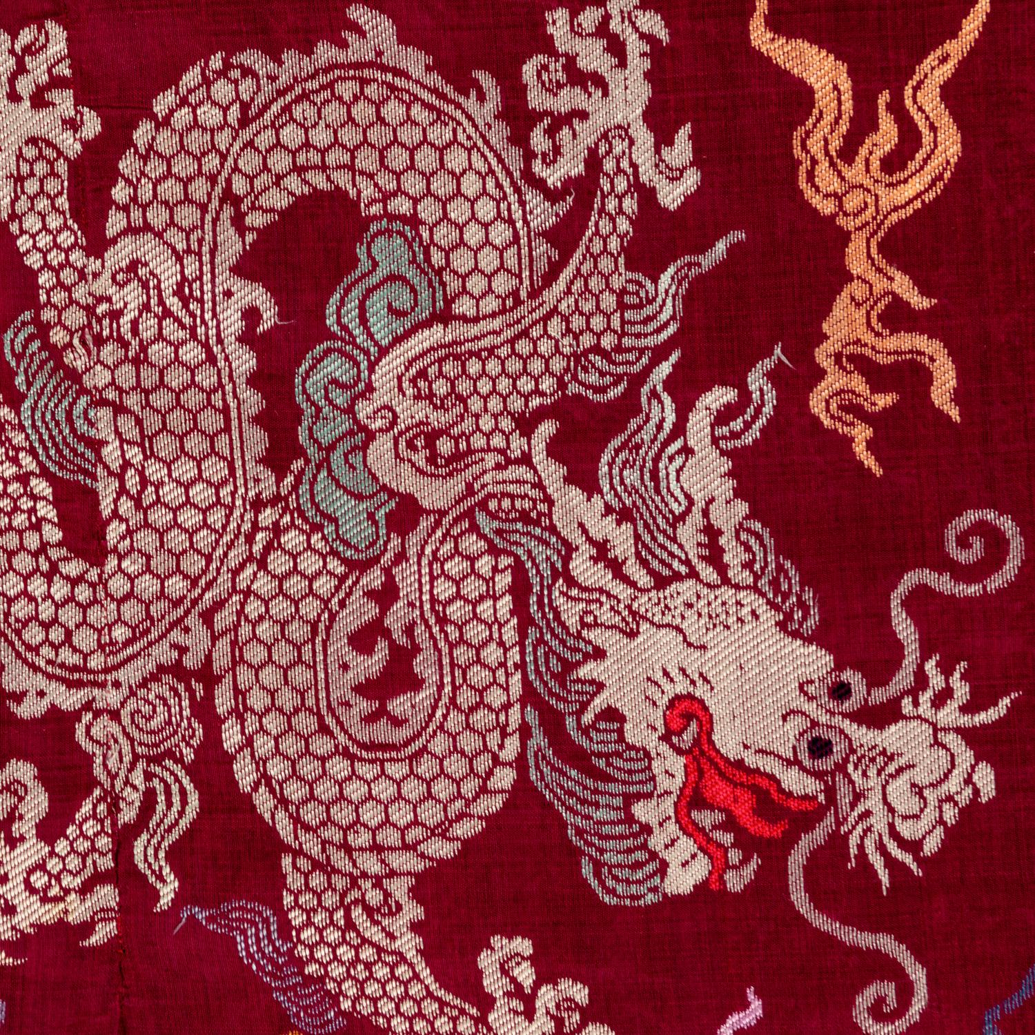 A Chinese Maroon Ground Silk Brocade 'Dragon' Robe, Jifu, Late Qing Dynasty 清晚期 絳紅地織錦龍紋吉服
