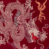 A Chinese Maroon Ground Silk Brocade 'Dragon' Robe, Jifu, Late Qing Dynasty 清晚期 絳紅地織錦龍紋吉服