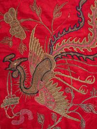A Pair of Chinese Red Ground Embroidered Silk Panels