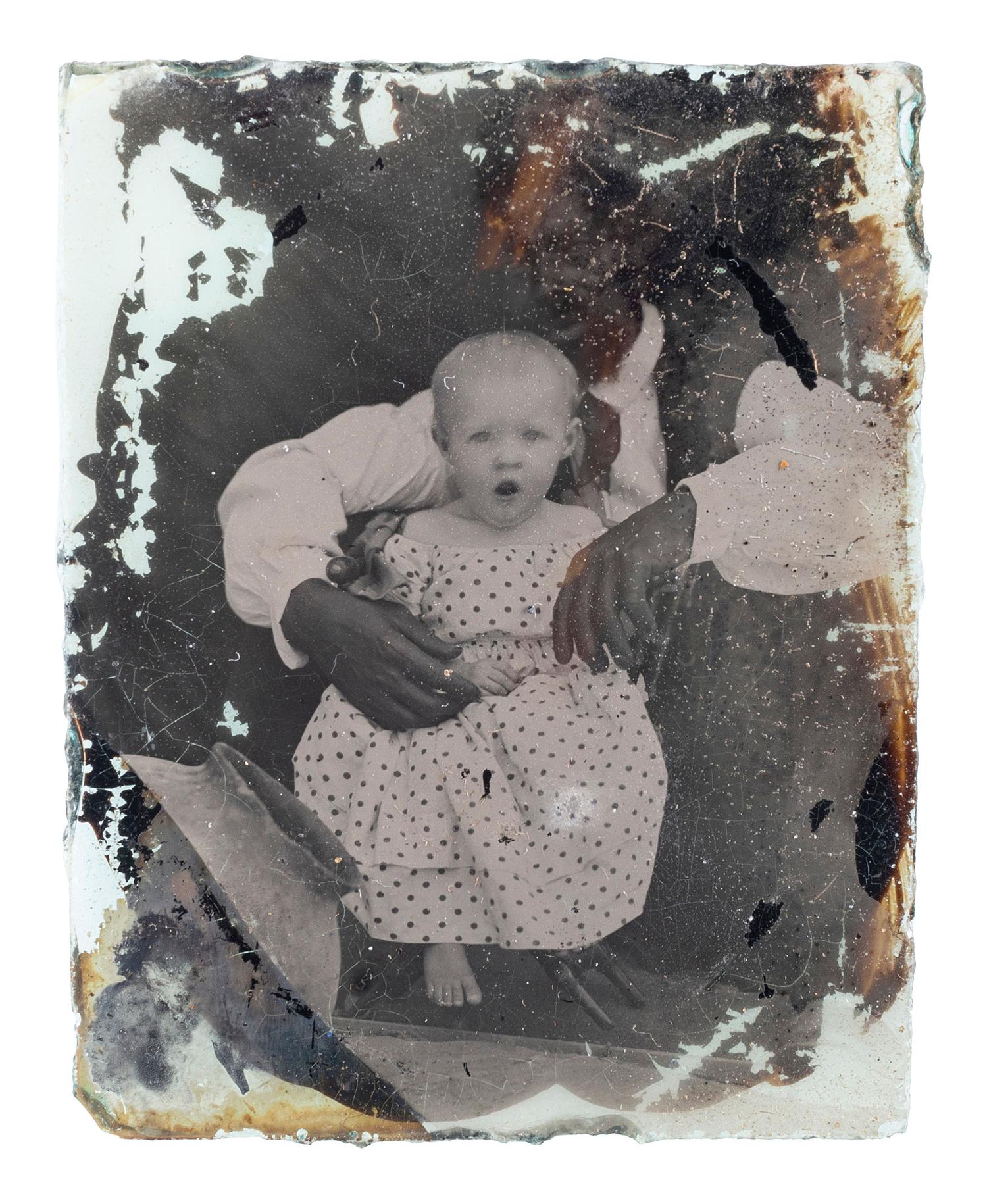 [EARLY PHOTOGRAPHY]. Ninth plate ambrotype of an African American man with white child, with rare Colonoware jar.