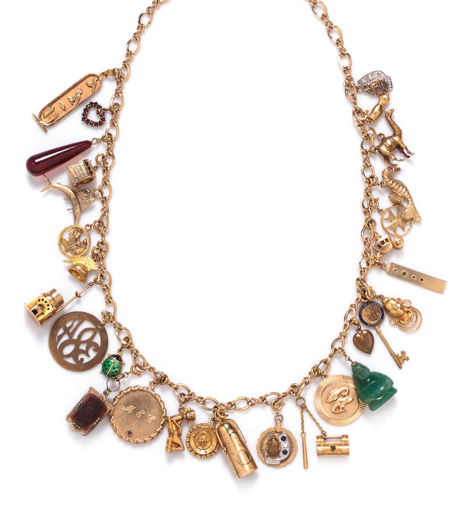A 14 Karat Yellow Gold Charm Necklace with 29 Attached Charms, 93.80 dwts.