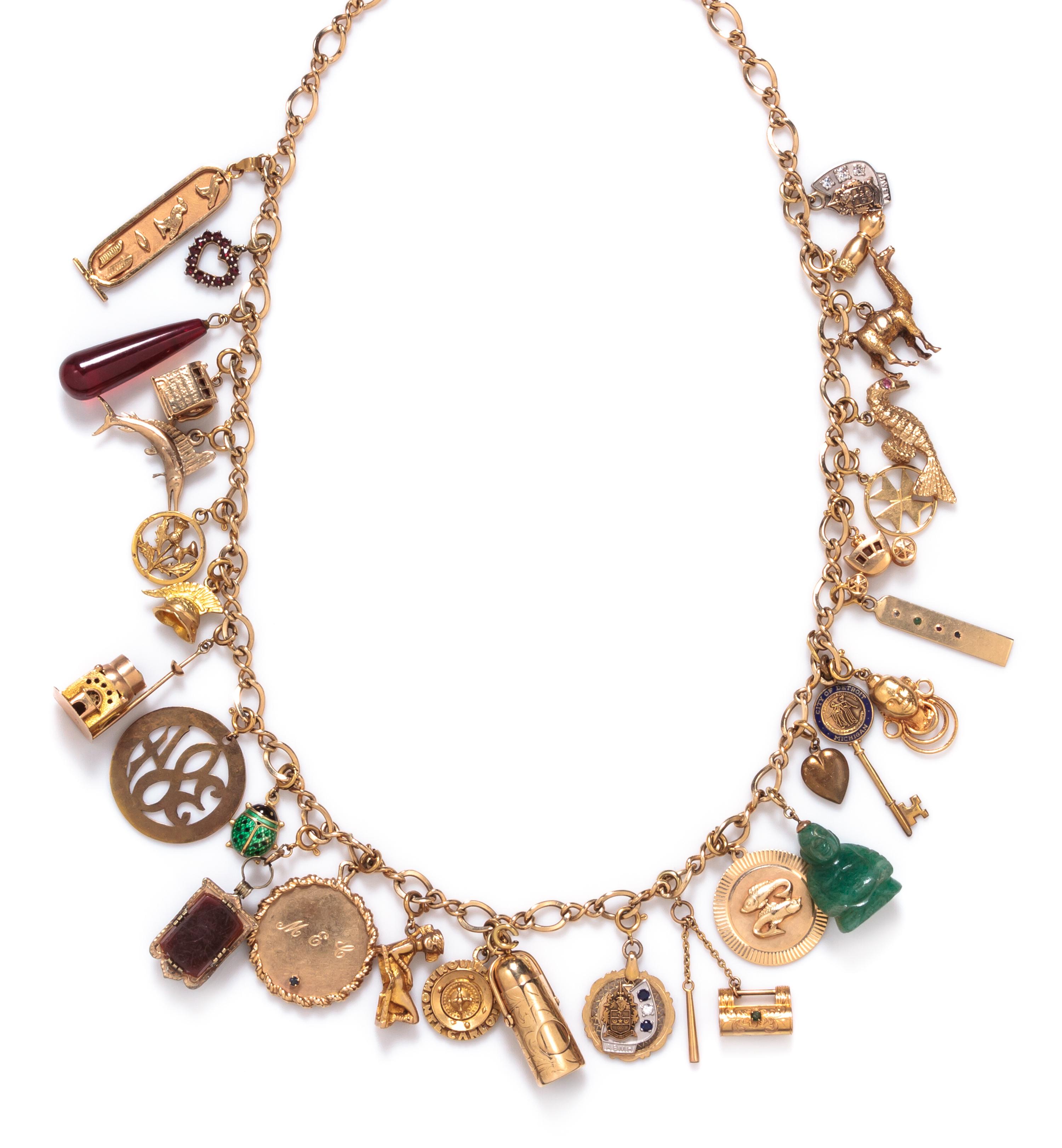 A 14 Karat Yellow Gold Charm Necklace with 29 Attached Charms, 93.80 dwts.