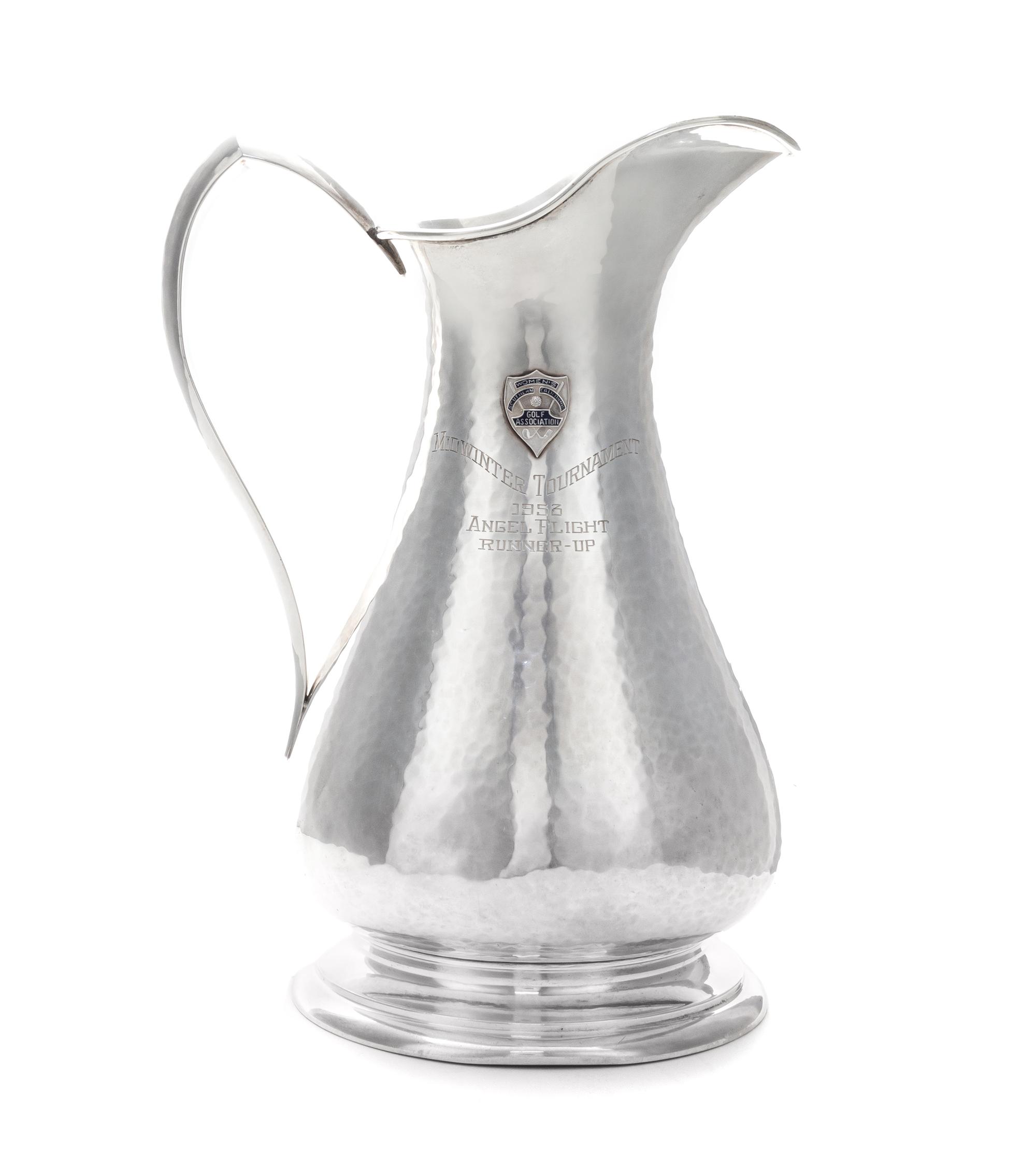 An American Silver Pitcher, Sedlacek & Co., Los Angeles, CA, 1945, of baluster form with a pointed loop handle, the spot-hammered surfa