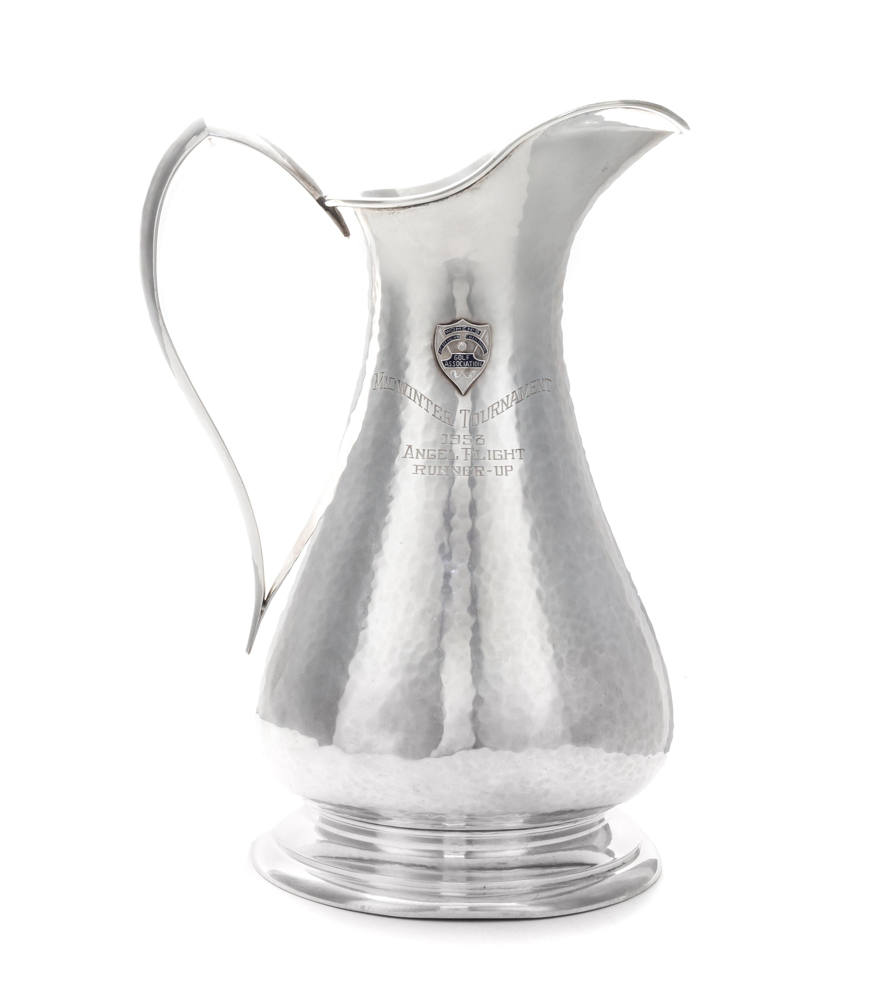 An American Silver Pitcher, Sedlacek & Co., Los Angeles, CA, 1945, of baluster form with a pointed loop handle, the spot-hammered surfa