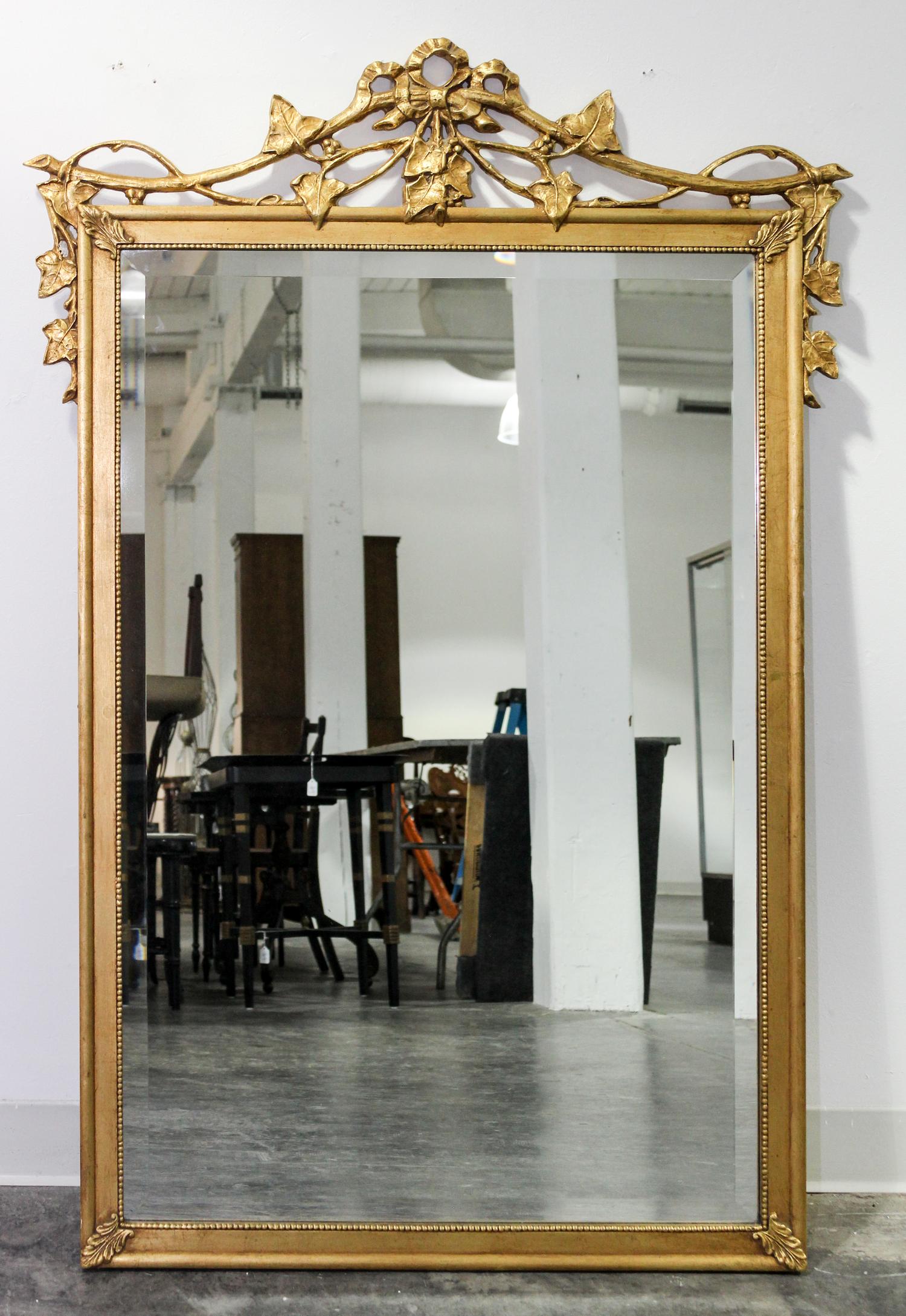 A Gilt Decorated Mirror Height 52 1/4 x width 36 inches.